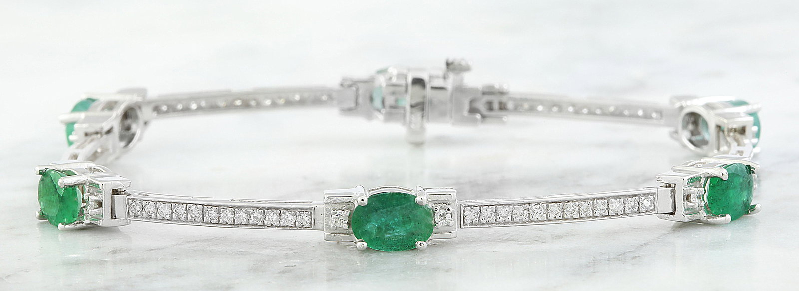 4.53 CTW Emerald 14K White Gold Diamond Bracelet: 4.53 CTW Emerald 14K White Gold Diamond Bracelet Manufacturer's Suggested Retail Price: $ 3400.00 Stamped: 14K Total Bracelet Weight: 11 Grams Bracelet Length: 7.0 Inches Emerald Weight: 4.01 Carat (7
