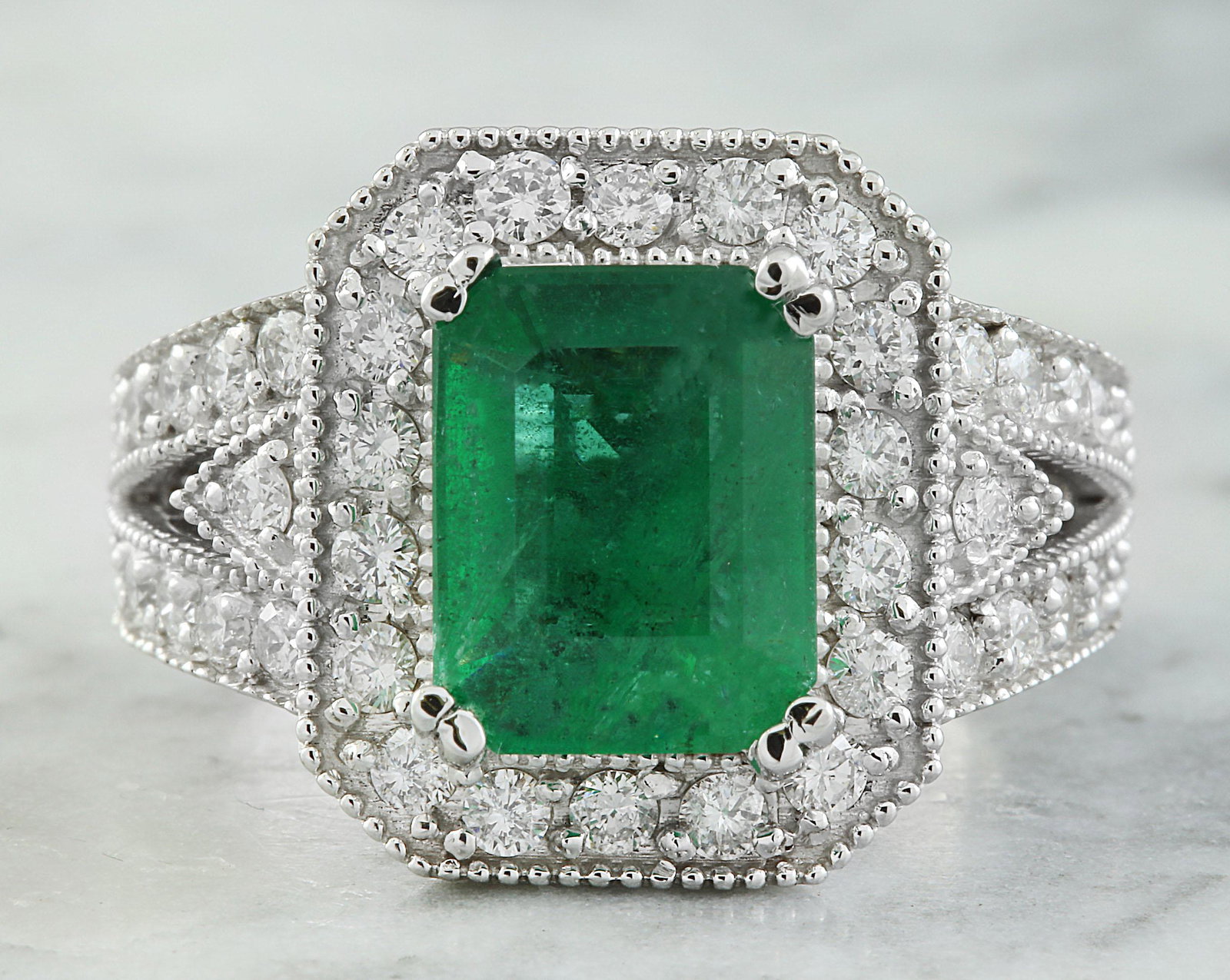 3.92 CTW Emerald 18K White Gold Diamond Ring: 3.92 CTW Emerald 18K White Gold Diamond Ring Manufacturer's Suggested Retail Price: $ 5400.00 Stamped: 18K Total Ring Weight: 10 Grams Emerald Weight: 2.92 Carat (10.00x7.80 Millimeters) Diamond Weigh
