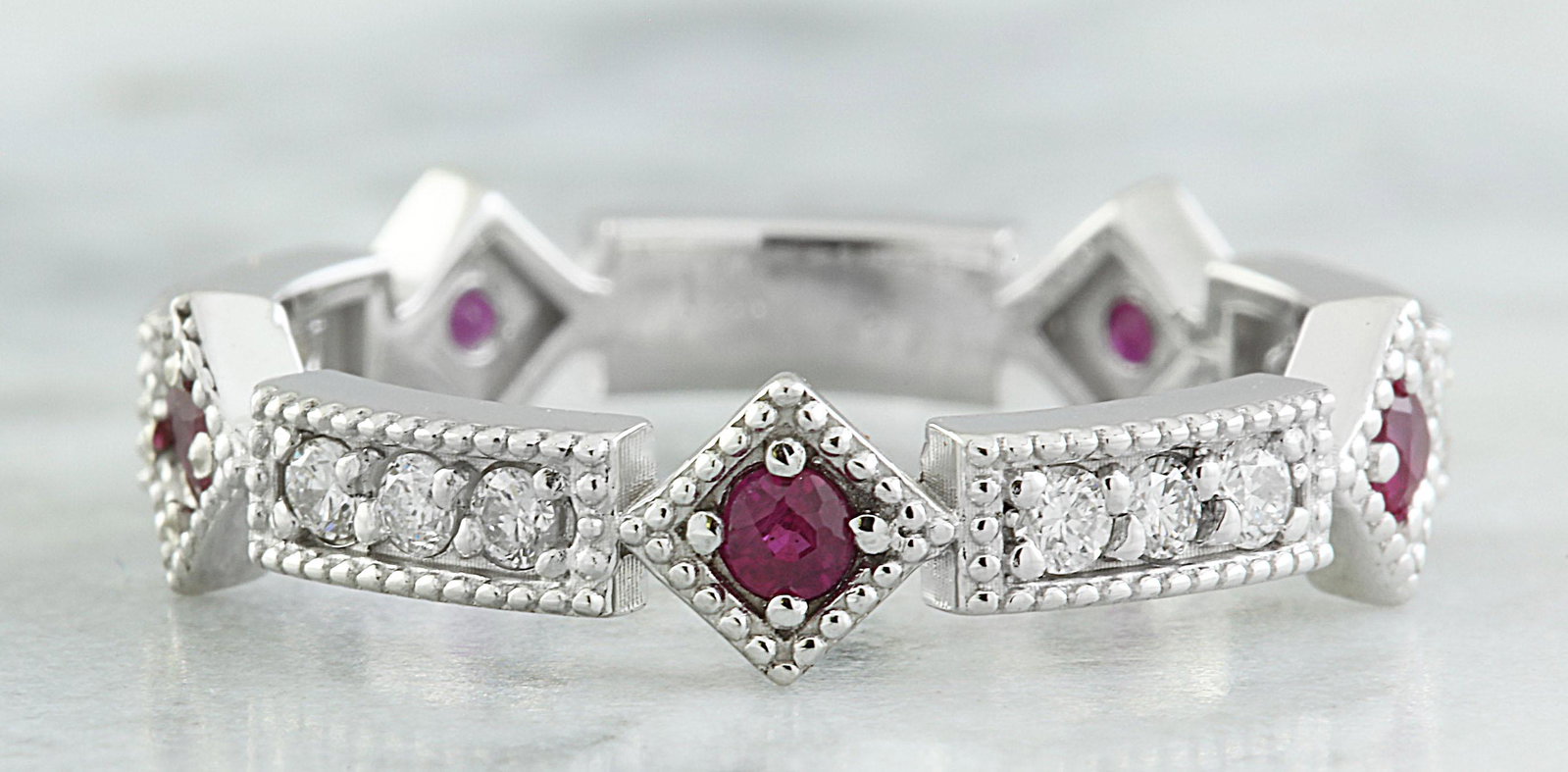 0.46 CTW Ruby 18K White Gold Diamond Ring: 0.46 CTW Ruby 18K White Gold Diamond Ring Manufacturer's Suggested Retail Price: $ 1900.00 Stamped: 18K Total Ring Weight: 2.8 Grams Ruby Weight: 0.18 Carat Diamond Weight: 0.28 carat (F-G Color, VS2-
