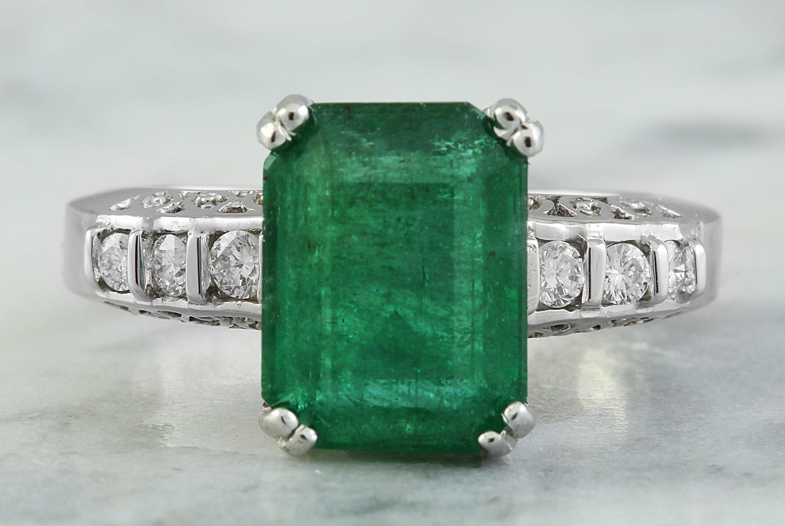 3.72 CTW Emerald 18K White Gold Diamond Ring: 3.72 CTW Emerald 18K White Gold Diamond Ring Manufacturer's Suggested Retail Price: $ 4500.00 Stamped: 18K Ring Size: 7 Total Ring Weight: 6.4 Grams Emerald Weight: 3.47 Carat (11.00x8.35 Millimeter) 