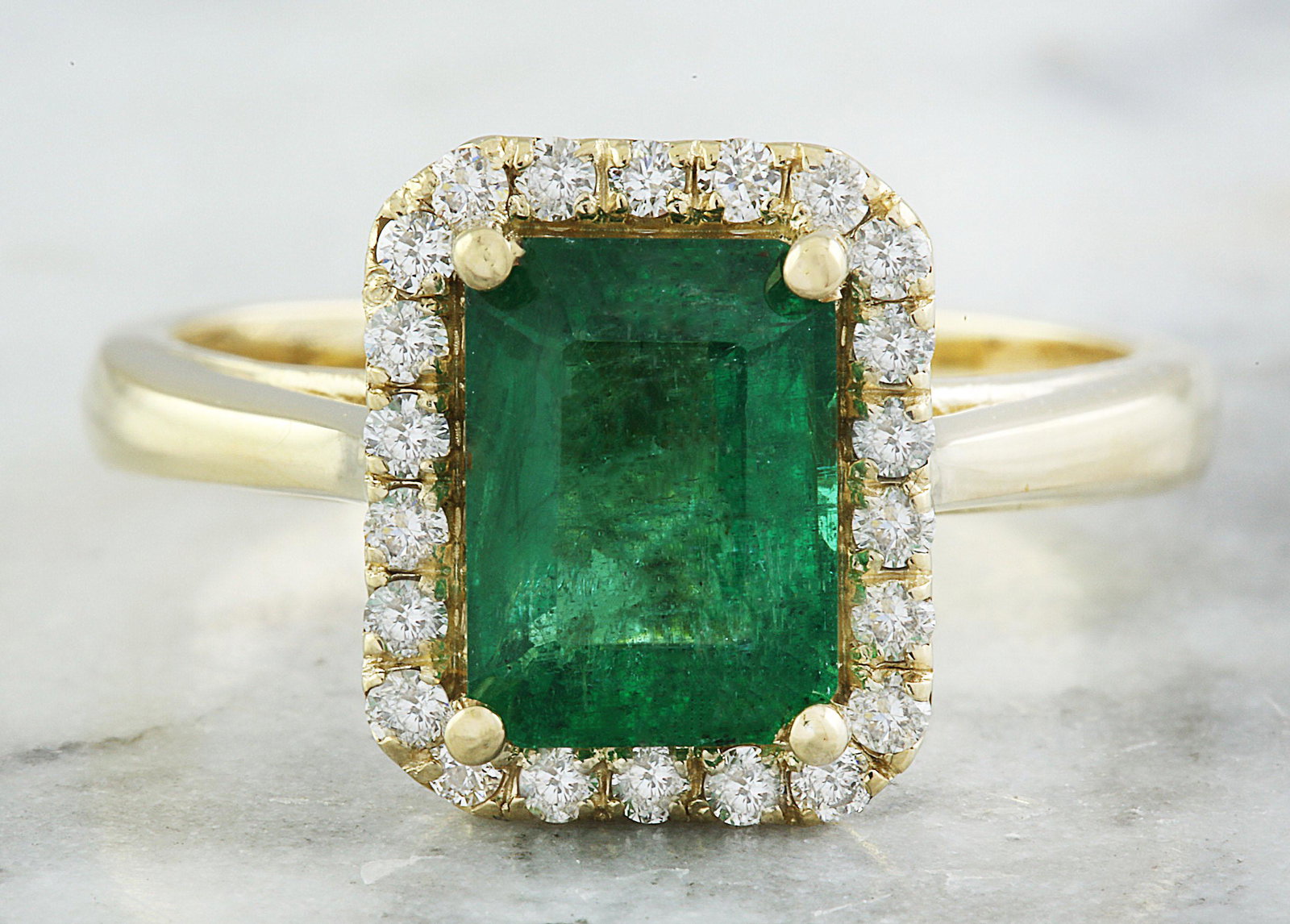 2.30 CTW Emerald 18K Yellow Gold Diamond Ring: 2.30 CTW Emerald 18K Yellow Gold Diamond Ring Manufacturer's Suggested Retail Price: $ 3300.00 Stamped: 18K Total Ring Weight: 5 Grams Emerald Weight 1.95 Carat (8.80x6.40 Millimeters) Diamond Weight: