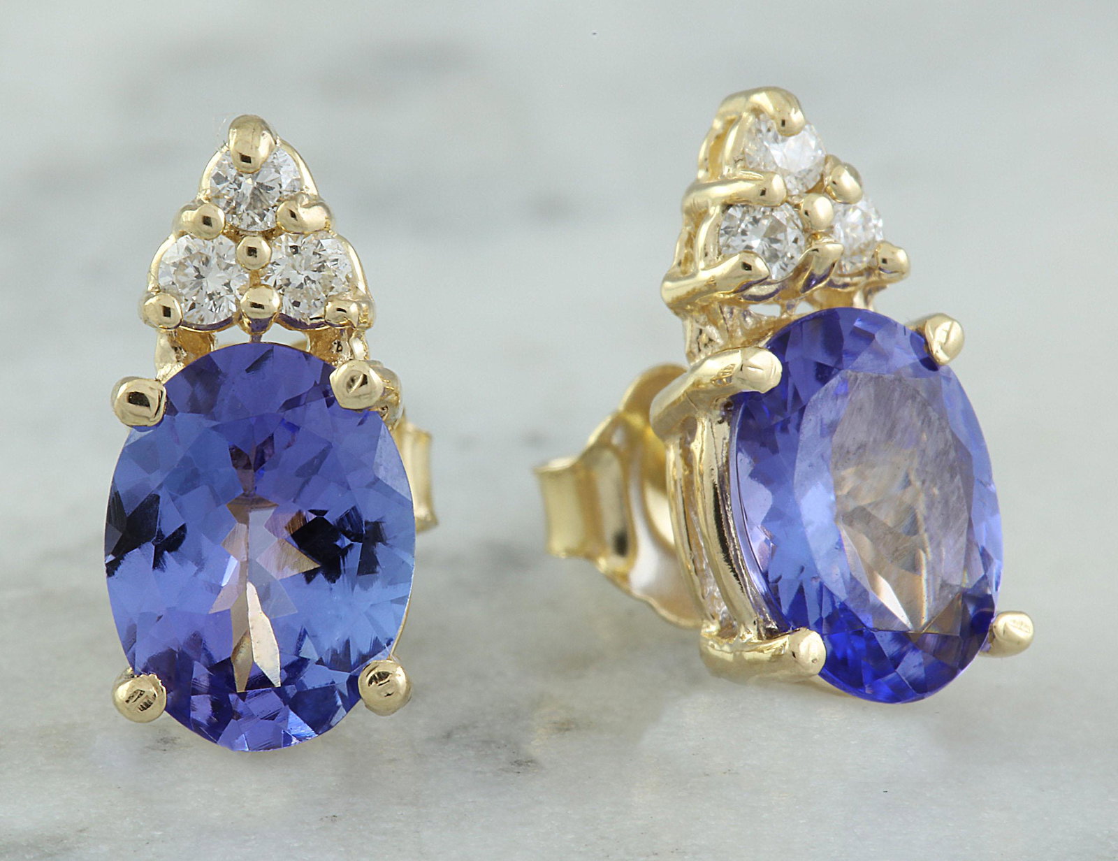 2.79 CTW Tanzanite 14K Yellow Gold Diamond Earrings: 2.79 CTW Tanzanite 14K Yellow Gold Diamond Earrings Manufacturer's Suggested Retail Price: $ 2200.00 Stamped: 14K Total Earrings Weight: 2.5 Grams Tanzanite Weight: 2.59 Carat (8.00x6.00 Millimeters) 