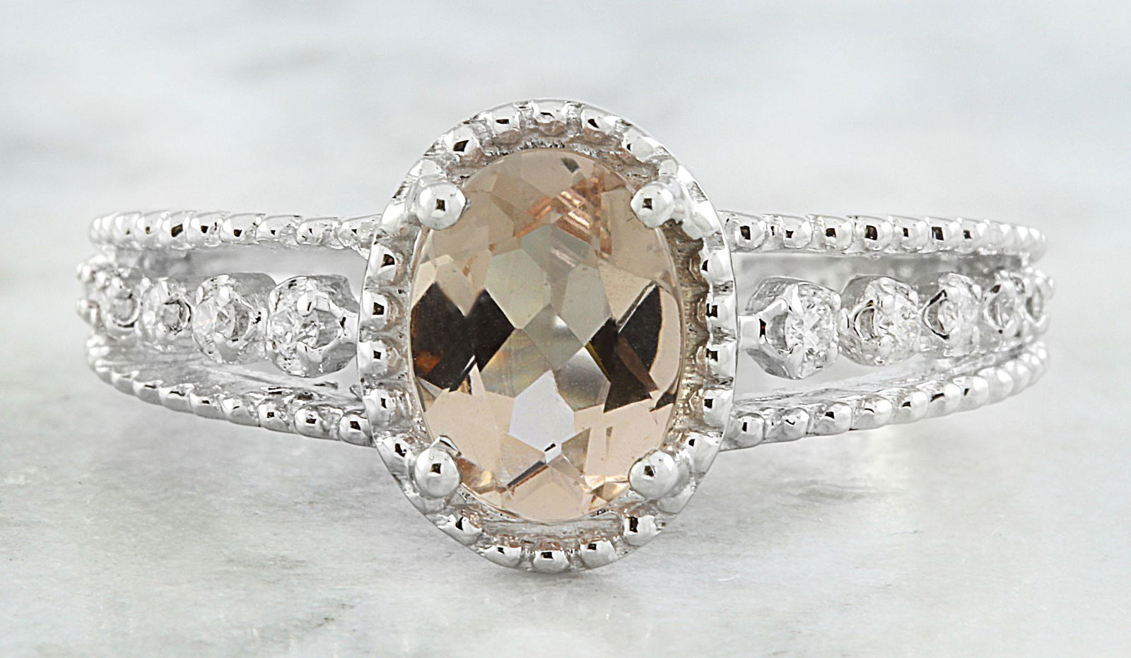 1.29 CTW Morganite 18K White gold Diamond Ring: 1.29 CTW Morganite 18K White gold Diamond Ring Manufacturer's Suggested Retail Price: $ 2200.00 Stamped: 18K Total Ring Weight: 4 Grams Sapphire Weight 1.19 Carat (8.00x6.00 Millimeters) Diamond Weigh