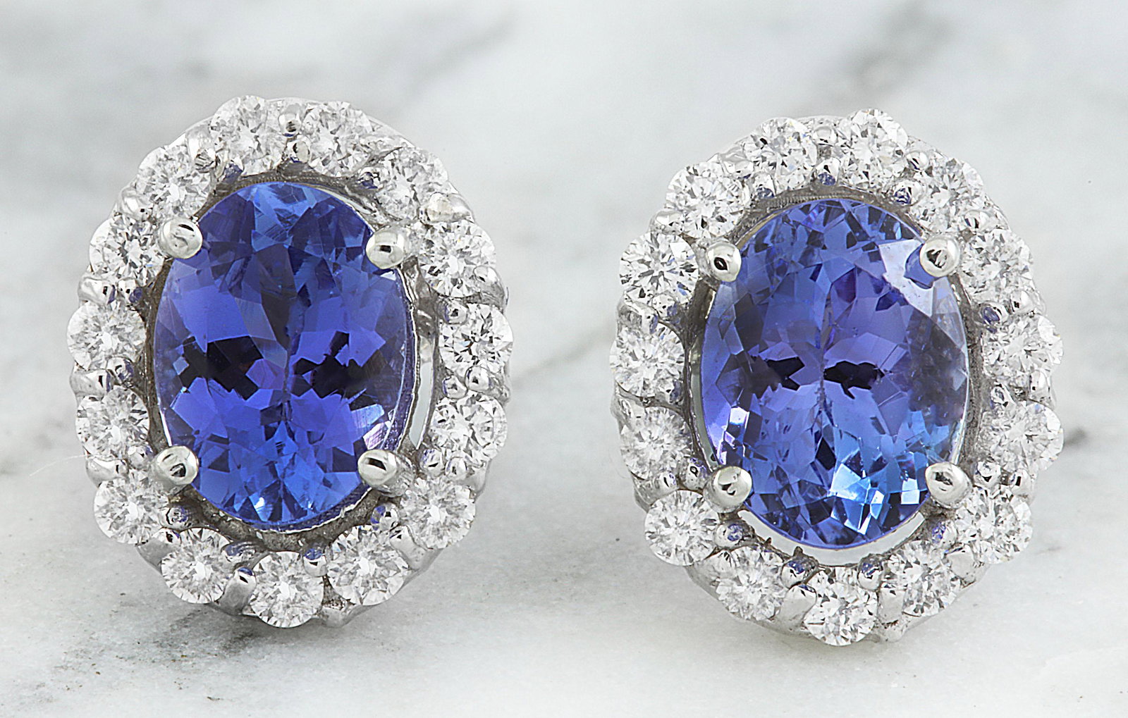 3.07 CTW Tanzanite 18K White Gold Diamond Earrings: 3.07 CTW Tanzanite 18K White Gold Diamond Earrings Manufacturer's Suggested Retail Price: $ 3400.00 Stamped: 18K Total Earrings Weight: 2.1 Grams Tanzanite Weight: 2.37 Carat (7.60x5.90 Millimeters) D