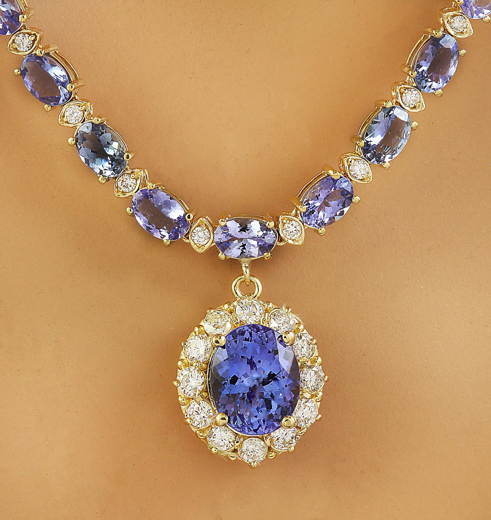 42.87 CTW Tanzanite 14K Yellow Gold Diamond Necklace: 42.87 CTW Tanzanite 14K Yellow Gold Diamond Necklace Manufacturer's Suggested Retail Price: $ 11600.00 Stamped: 14K Total Necklace Weight: 27.1 Grams Necklace Length: 18.5 Inches Center Tanzanite Weig