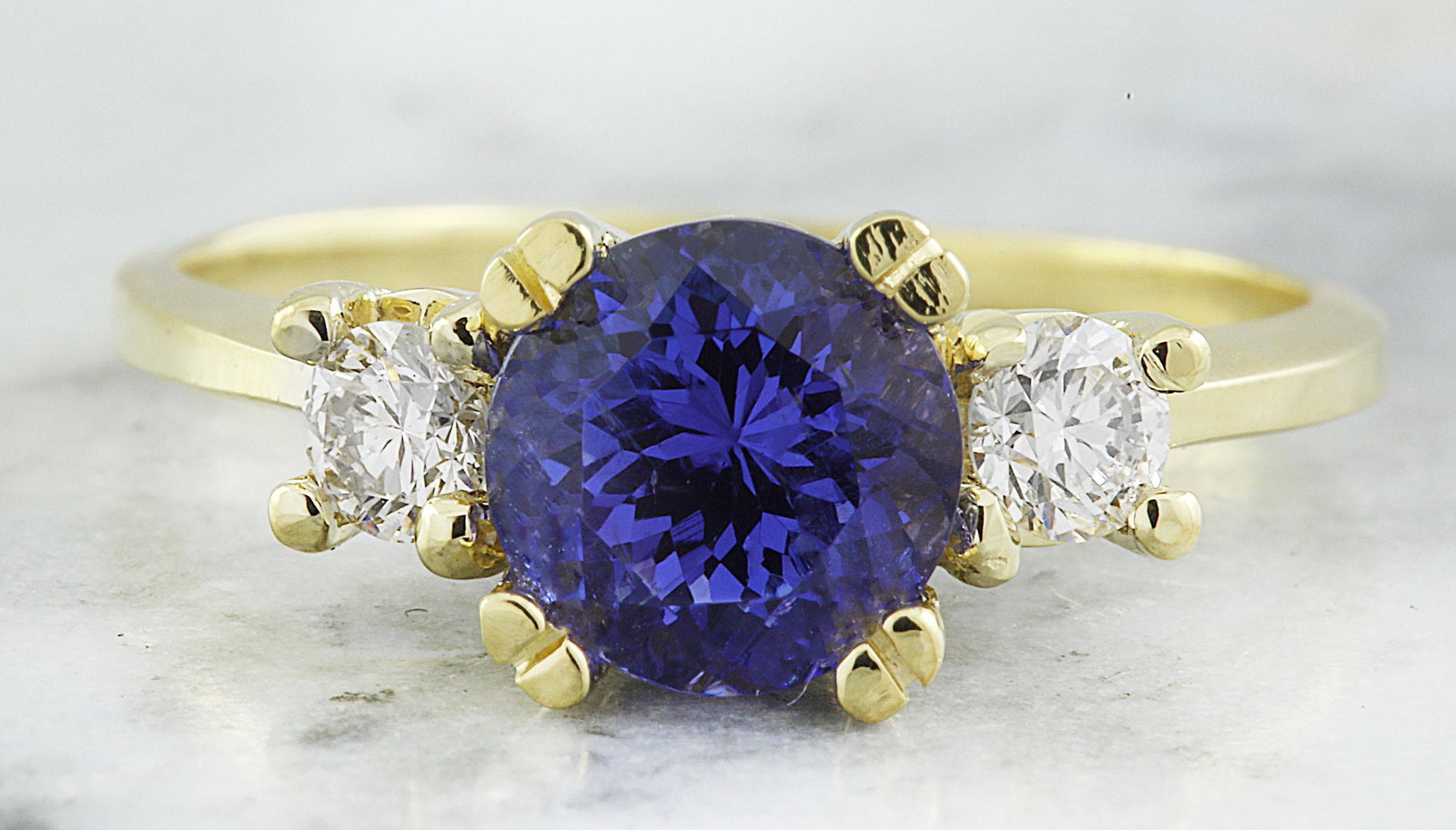 1.93 CTW Tanzanite 14K Yellow Gold Diamond Ring: 1.93 CTW Tanzanite 14K Yellow Gold Diamond Ring Manufacturer's Suggested Retail Price: $ 2700.00 Stamped: 14K Total Ring Weight: 4 Grams Tanzanite Weight 1.63 Carat (7.20x7.20 Millimeters) Diamond Wei