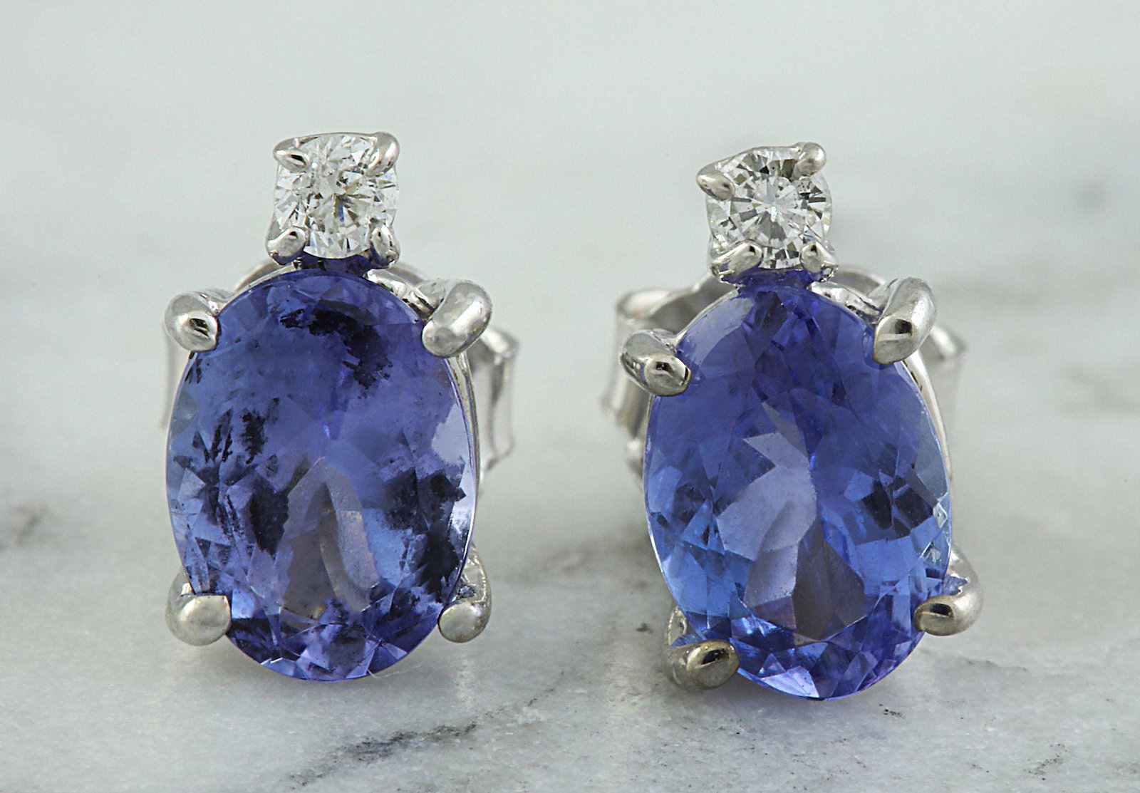 3.26 CTW Tanzanite 18K White Gold Diamond Earrings: 3.26 CTW Tanzanite 18K White Gold Diamond Earrings Manufacturer's Suggested Retail Price: $ 2100.00 Stamped: 18K Total Earrings Weight: 1.6 Grams Tanzanite Weight: 3.20 Carat (8.90x6.40 Millimeters) D