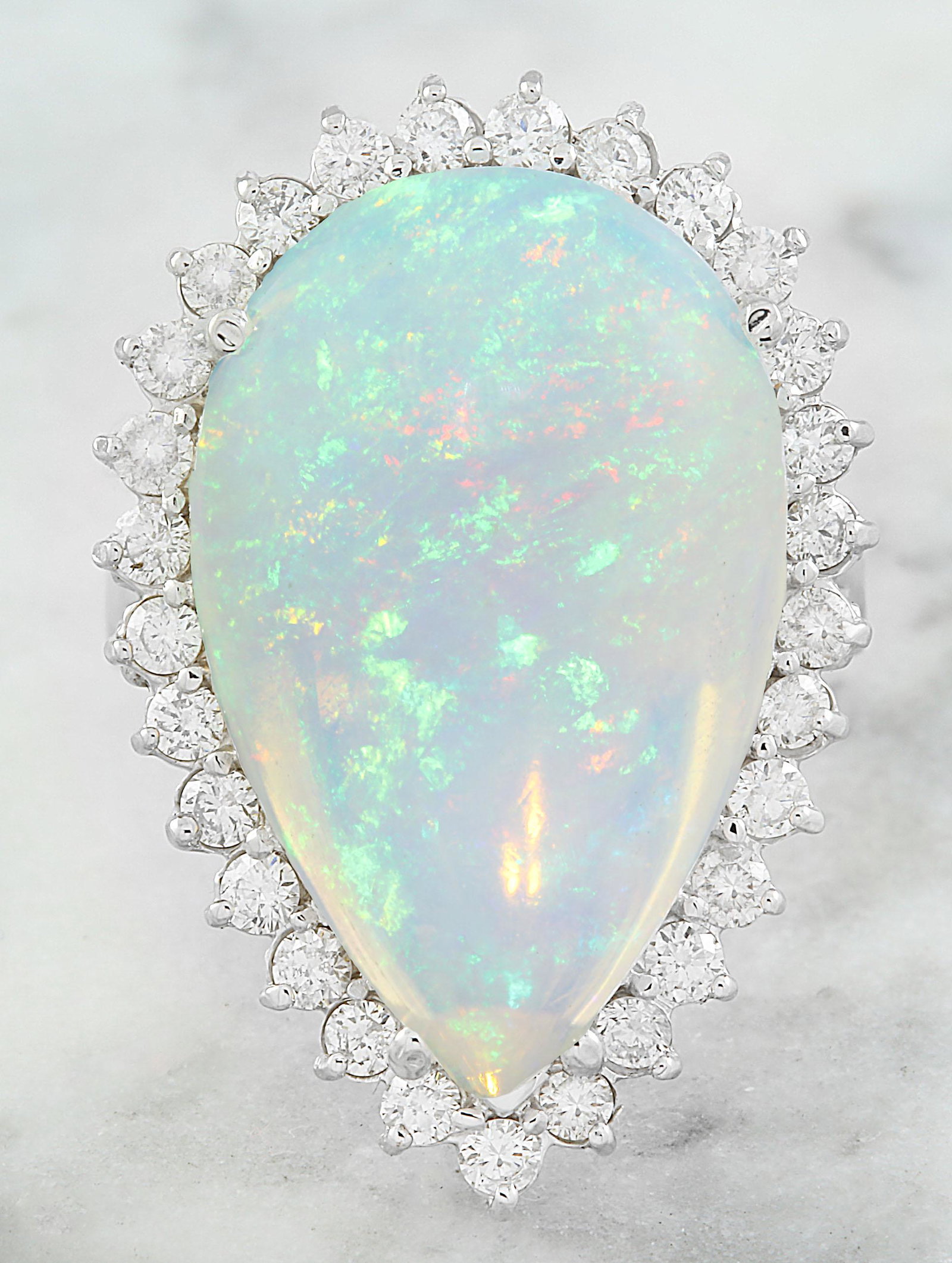 14.00 Carat Opal 18K White Gold Diamond Ring: Stamped: 18K Total Ring Weight: 12.7 Grams Opal Weight 12.90 Carat (22.90x14.70 Millimeters) Diamond Weight: 1.10 carat (F-G Color, VS2-SI1 Clarity ) Face Measures: 28.60x19.65 Millimeter SKU: [600870