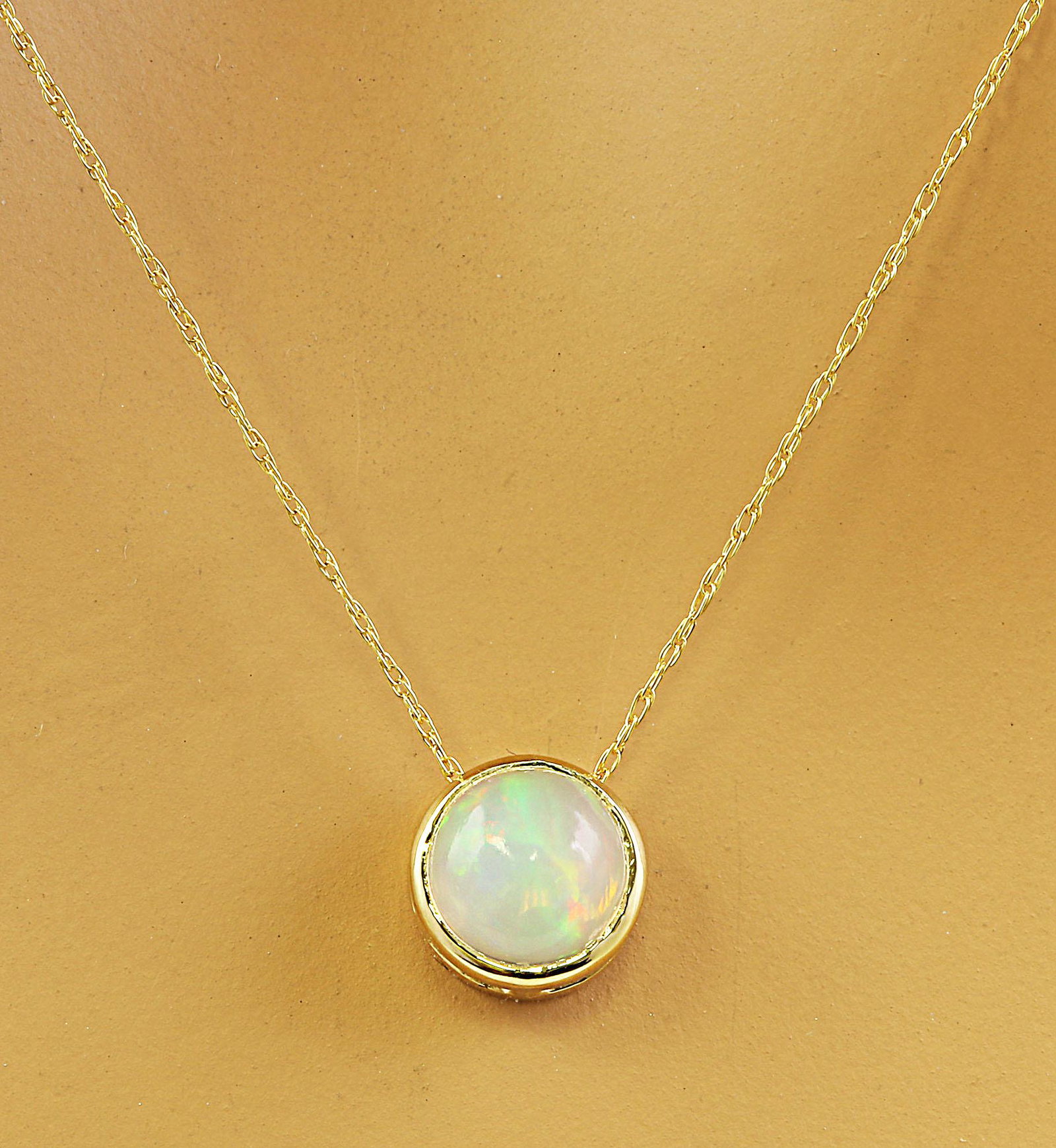1.50 Carat Opal 14K Yellow Gold Necklace: 1.50 Carat Opal 14K Yellow Gold Necklace Stamped: 14K Total Necklace Weight: 1.4 Grams LengthL 18 Inches Opal Weight: 1.50 Carat (6.50x6.50 Millimeters) Face Measures: 8.20x8.20 Millimeter SKU: [60019