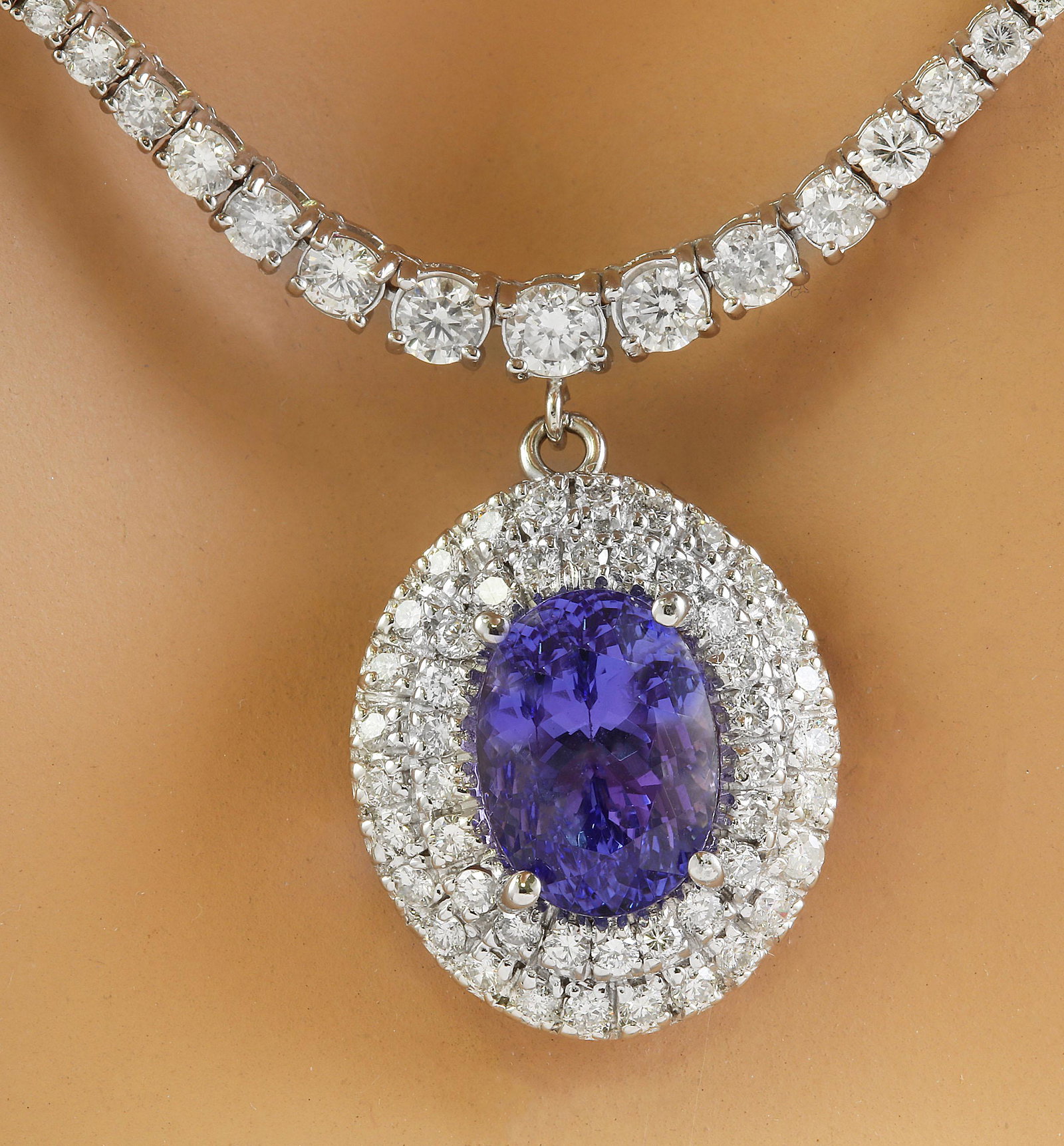 12.11 Carat Tanzanite 18K White Gold Diamond Necklace: 12.11 Carat Tanzanite 18K White Gold Diamond Necklace Stamped: 18K Total Necklace Weight: 20.2 Grams Length: 17 Inches Tanzanite Weight: 6.01 Carat (11.90x8.75 Millimeter) Diamond Weight: 6.10 Carat (