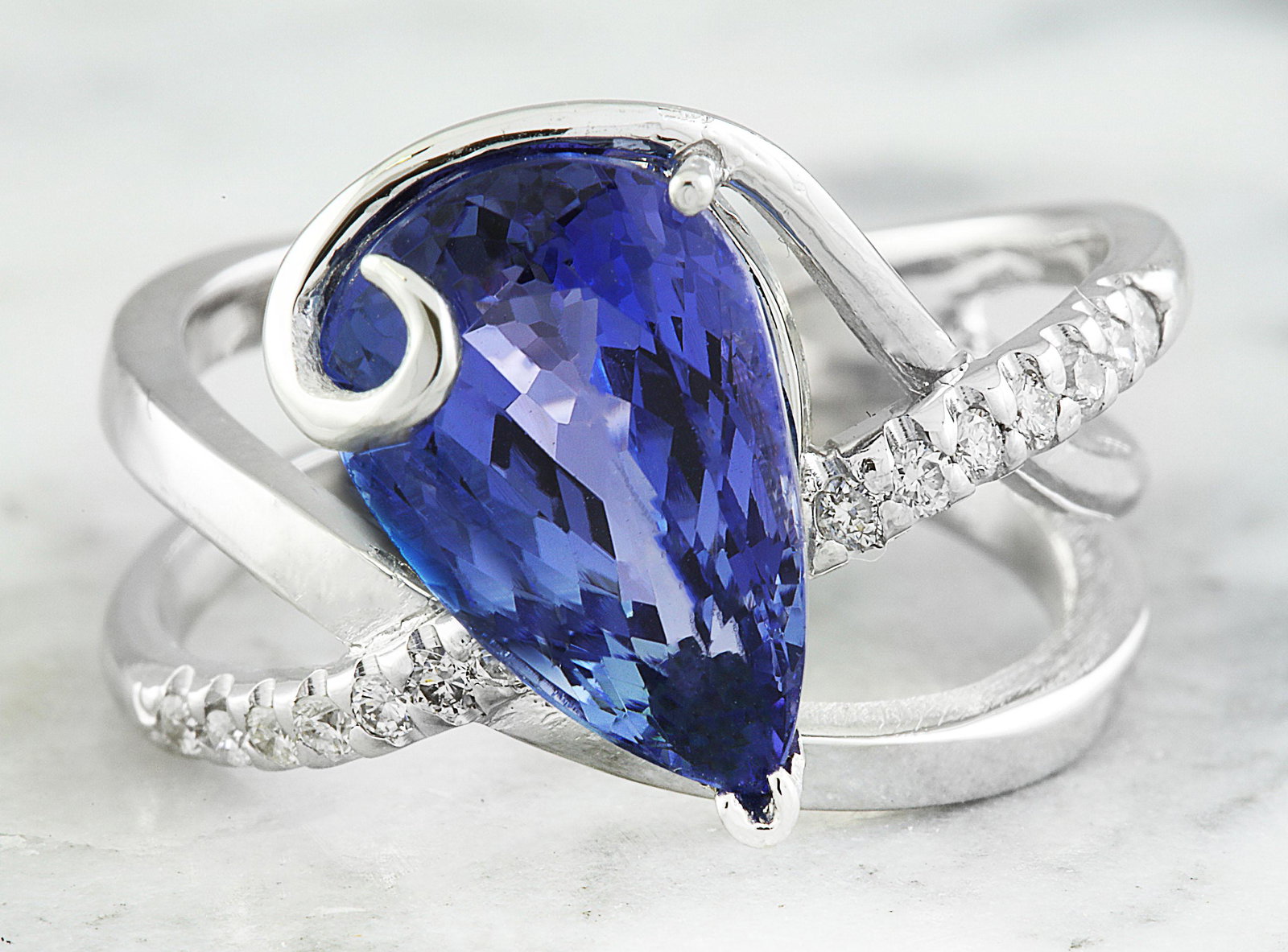 5.75 Carat Tanzanite 18K White Gold Diamond Ring: 5.75 Carat Tanzanite 18K White Gold Diamond Ring Stamped: 18K Total Ring Weight: 7.4 Grams Tanzanite Weight 5.60 Carat (12.75x8.40 Millimeters) Diamond Weight: 0.15 carat (F-G Color, VS2-SI1 Clarity )