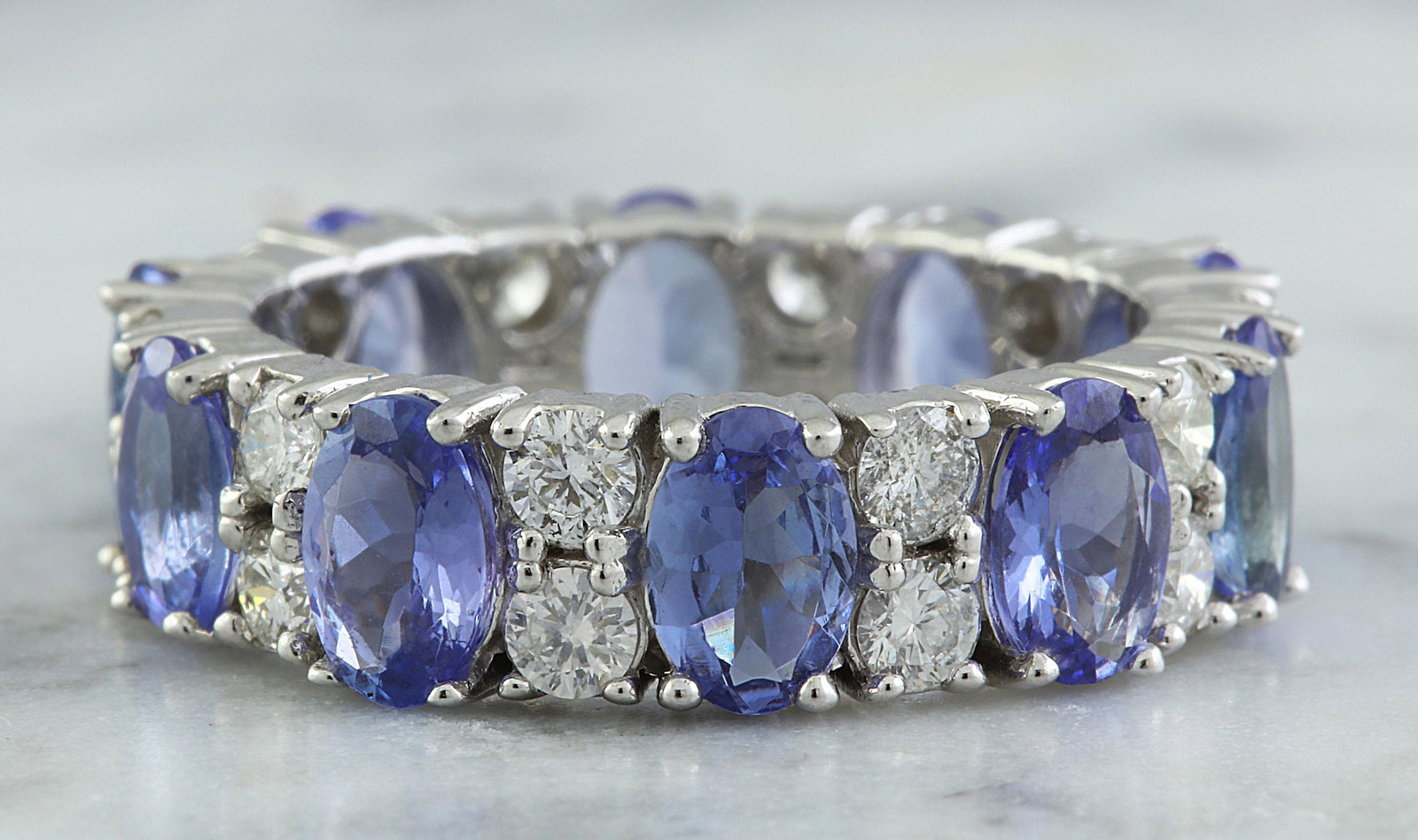 6.94 Carat Tanzanite 18K White Gold Diamond Ring: 6.94 Carat Tanzanite 18K White Gold Diamond Ring Stamped: 18K Ring Size: 7 Total Ring Weight: 5.2 Grams Tanzanite Weight: 5.78 Carat (6.00x4.00 Millimeter) Diamond Weight: 1.16 Carat (F-G Color, VS2-S