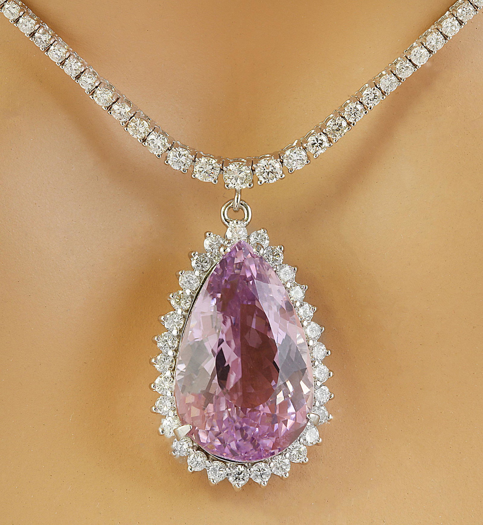 31.36 Carat Kunzite 14K White Gold Diamond Necklace: 31.36 Carat Kunzite 14K White Gold Diamond Necklace Stamped: 14K Total Necklace Weight: 20.2 Grams Necklace Length 16 Inches Kunzite Weight: 24.16 Carat (22.90x14.50 Millimeters) Diamond Weight: 7.20 