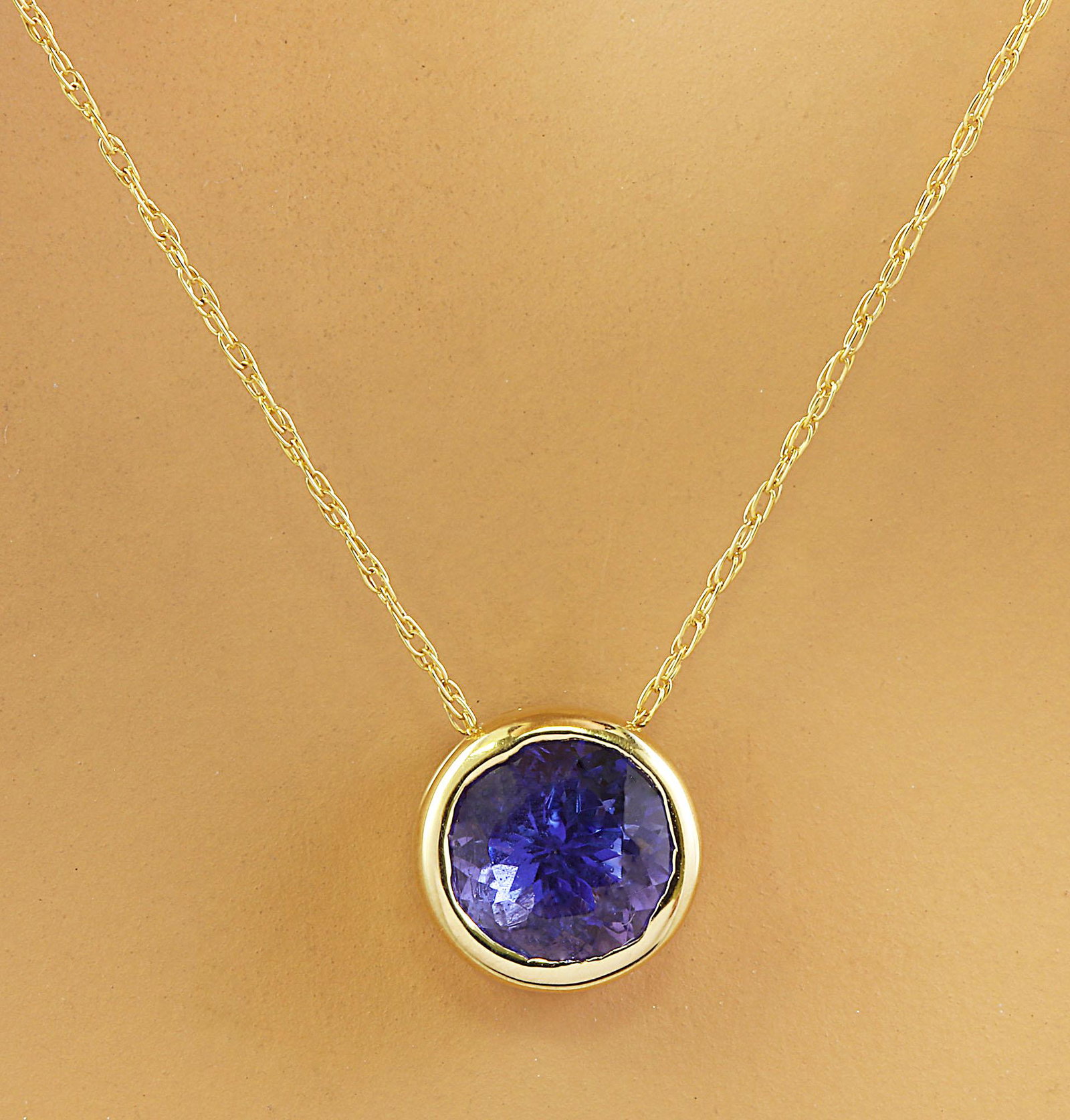 1.50 Carat Tanzanite 18K Yellow Gold Necklace: 1.50 Carat Tanzanite 18K Yellow Gold Necklace Stamped: 18K Total Necklace Weight: 1.4 Grams Length: 18 Inches Tanzanite Weight: 1.50 Carat (6.50x6.50 Millimeters) Face Measures: 8.20x8.20 Millimeter S