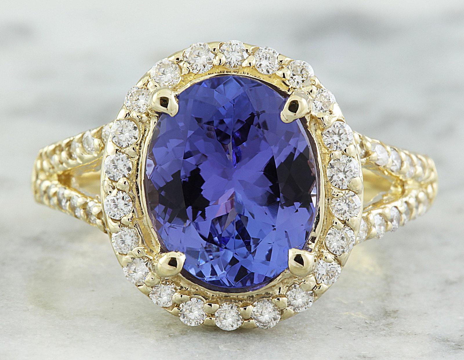 1.95 Carat Tanzanite 14K Yellow Gold Diamond Ring: 1.95 Carat Tanzanite 14K Yellow Gold Diamond Ring Stamped: 14K Total Ring Weight: 4 Grams Tanzanite Weight 1.50 Carat (9.00x7.00 Millimeters) Diamond Weight: 0.45 carat (F-G Color, VS2-SI1 Clarity ) S