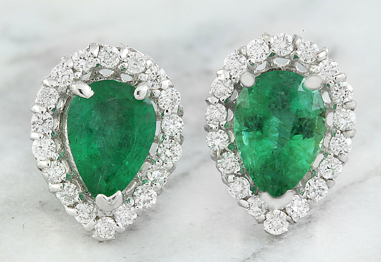 1.40 Carat Emerald 14K White Gold Diamond Earrings: 1.40 Carat Emerald 14K White Gold Diamond Earrings Stamped: 14K Total Earrings Weight: 1.2 Grams Emerald Weight: 1.12 Carat (7.00x4.90 Millimeters) Diamond Weight: 0.28 Carat (F-G Color, VS2-SI1 Clari