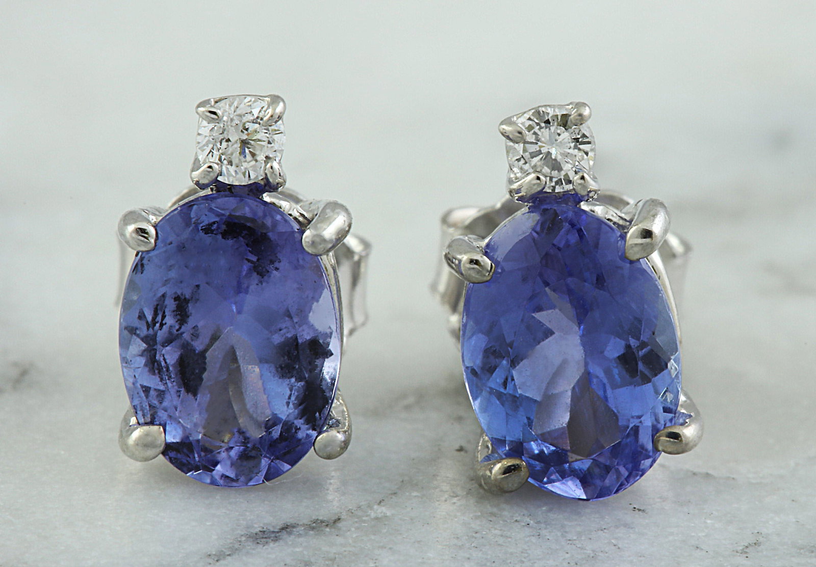 3.26 Carat Tanzanite 14K White Gold Diamond Earrings: 3.26 Carat Tanzanite 14K White Gold Diamond Earrings Stamped: 14K Total Earrings Weight: 1.6 Grams Tanzanite Weight: 3.20 Carat (8.90x6.40 Millimeters) Diamond Weight: 0.06 Carat (F-G Color, VS2-SI1 C
