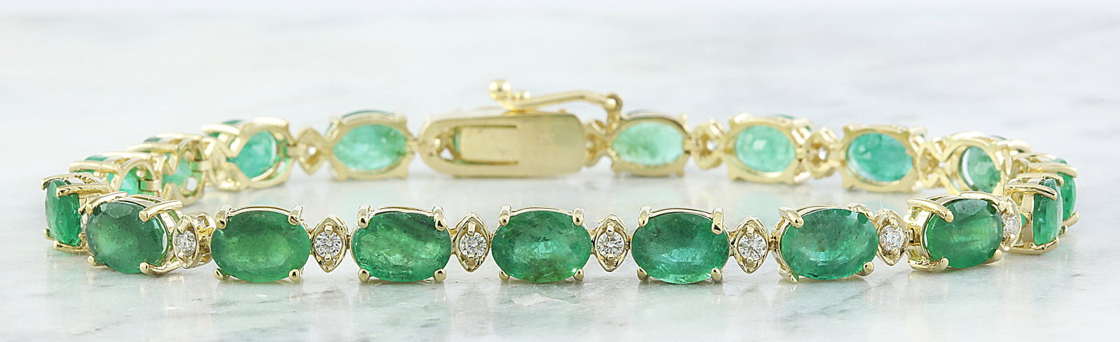 15.29 Carat Emerald 14K Yellow Gold Diamond Bracelet: 15.29 Carat Emerald 14K Yellow Gold Diamond Bracelet Stamped: 14K Total Bracelet Weight: 10.2 Grams Bracelet Length: 7 Inches Emerald Weight: 14.59 Carat (7.00x5.00 Millimeter) Diamond Weight: 0.70 Ca