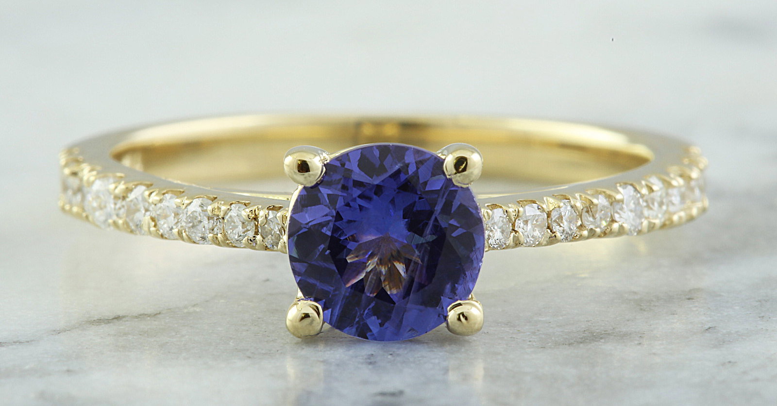 1.28 Carat Tanzanite 14K Yellow Gold Diamond Ring: 1.28 Carat Tanzanite 14K Yellow Gold Diamond Ring Stamped: 14K Ring Size: 7 Total Ring Weight: 2.9 Grams Tanzanite Weight: 1.00 Carat (6.00x6.00 Millimeter) Diamond Weight: 0.28 Carat (F-G Color, VS2-
