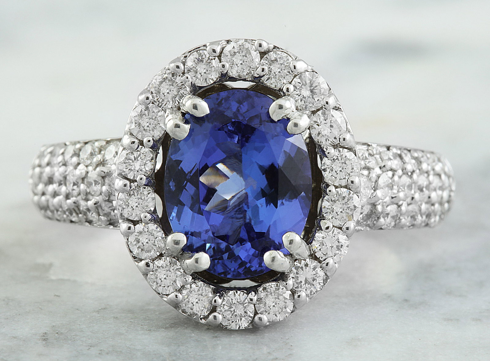 4.64 Carat Tanzanite 18K White Gold Diamond Ring: 4.64 Carat Tanzanite 18K White Gold Diamond Ring Stamped: 18K Total Ring Weight: 7.2 Grams Tanzanite Weight: 3.74 Carat (11.00x8.00 Millimeters) Diamond Weight: 0.90 Carat (F-G Color, VS2-SI1 Clarity 