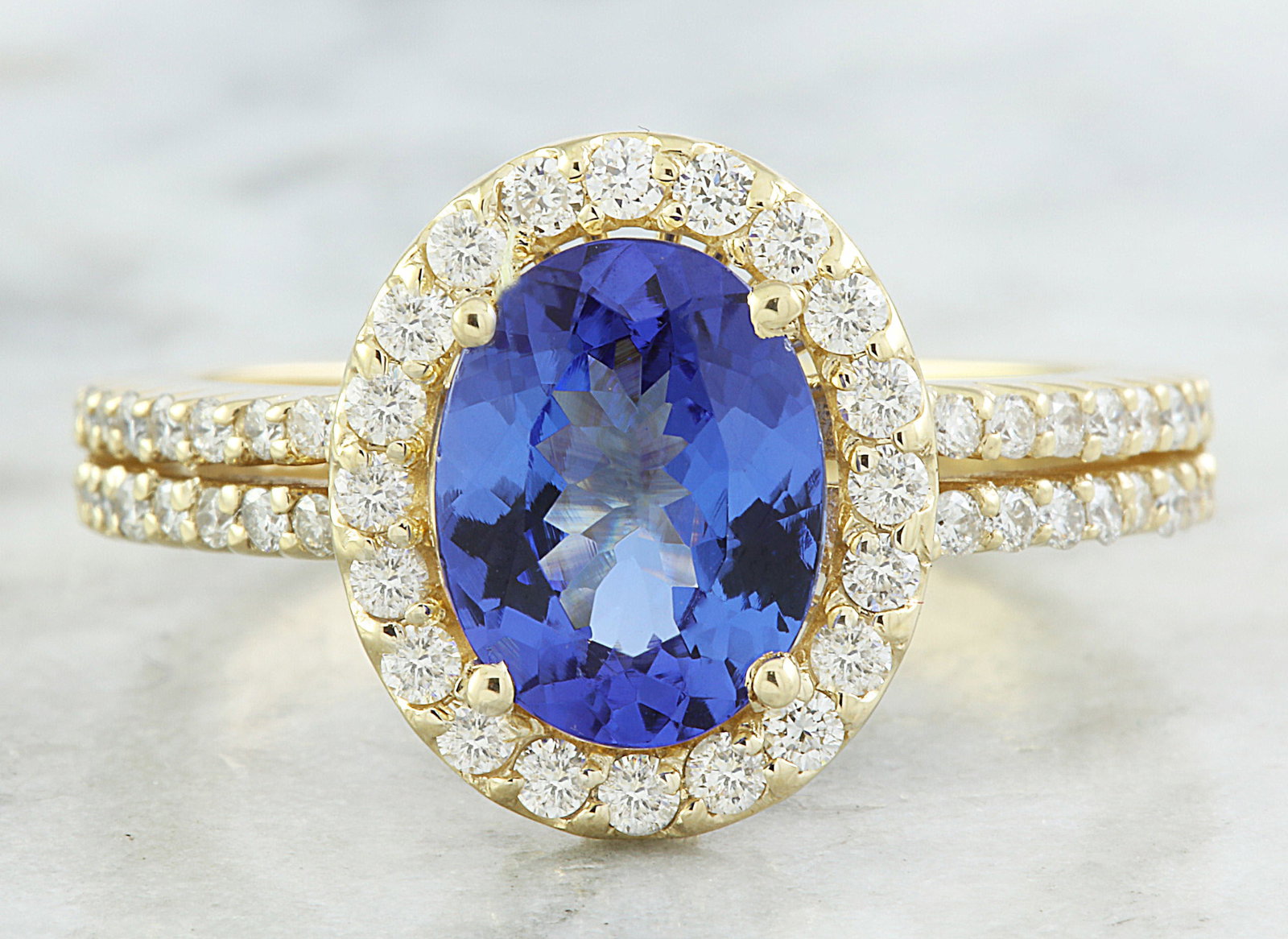 2.34 Carat Tanzanite 18K Yellow Gold Diamond Ring: 2.34 Carat Tanzanite 18K Yellow Gold Diamond Ring Stamped: 18K Total Ring Weight: 4.9 Grams Tanzanite Weight 1.84 Carat ( 9.00x7.00 Millimeters) Diamond Weight: 0.50 carat (F-G Color, VS2-SI1 Clarity 
