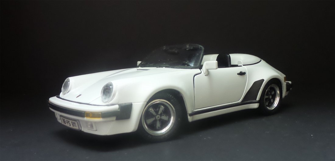 VINTAGE AMT 1989 PORSCHE 911 SPEEDSTER: Vintage 1989 Porsche 911 speedster. Metal Dealership Promotional Car by AMT. white and blue body color. All car features are stated on the underside of the car. License plate reads: BB-PS 911. All whe