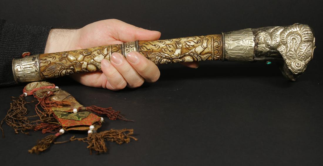 Tibet 1940/1950 AD Handmade femor bone Kangling 37,5 cm: Tibet. 1940/1950 AD. Handmade femor bone Kangling. Silver Ram Head on the top. Mahakala deity as decoration. 446 gr. - 37,5x6x6,5 cm. Kangling. literally translated as "leg" (kang) "flute" (ling), is