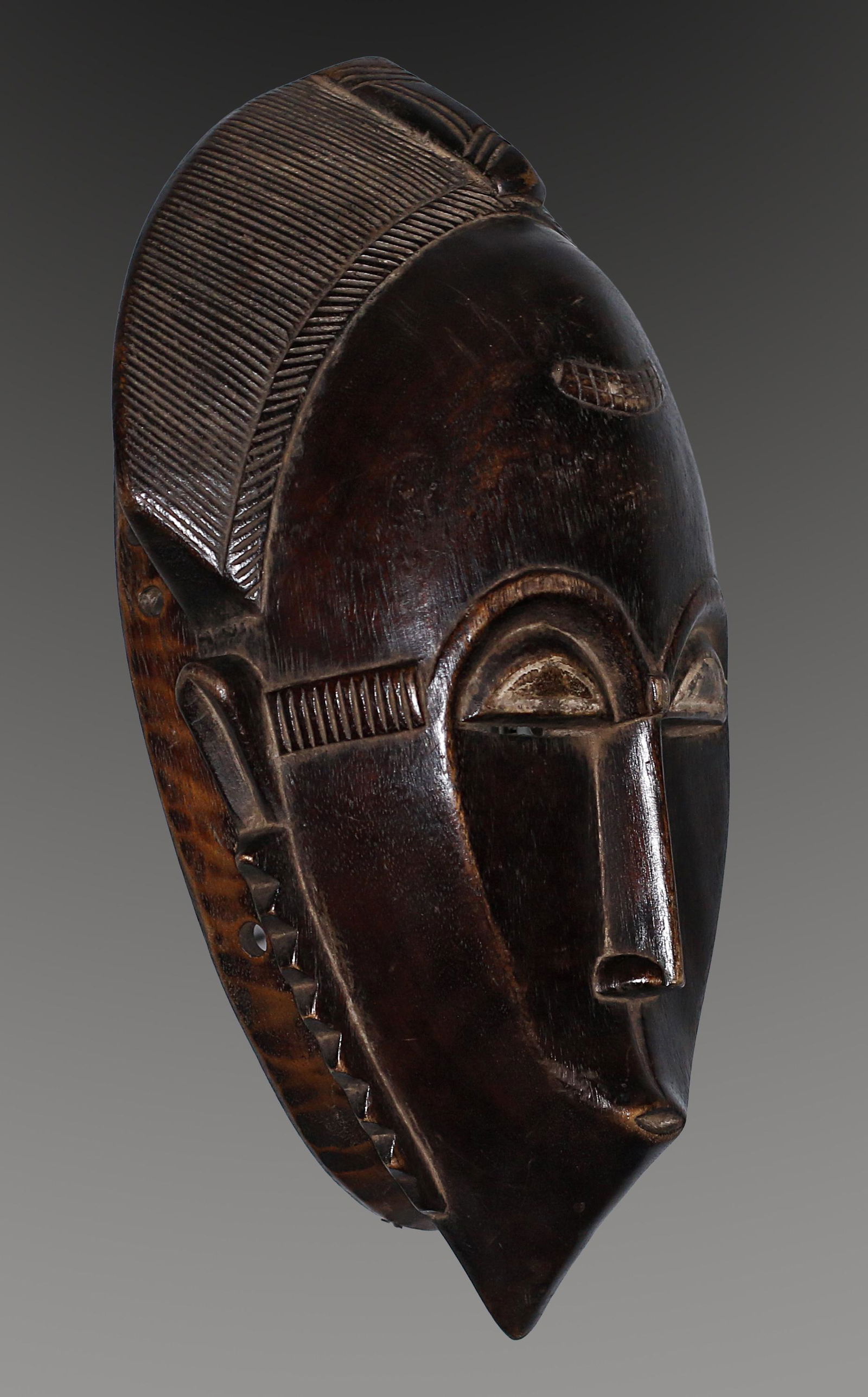 Ivory Coast Baule people Old Ceremonial mask 1970: Ivory Coast Baule people. Old Ceremonial mask. Traces of white pigmentation. 1970 circa. 957 gr. - 34x20x12 cm. Extremely fine. Rare. Provenance Fall Elhadji. The Baule are one of the Akan peoples. Th