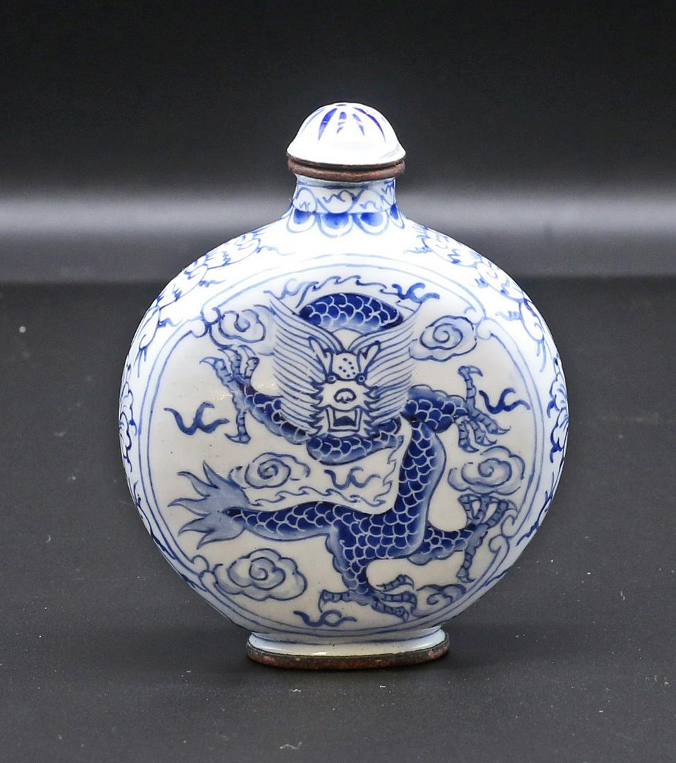China Min Guo period 1920 Handmade blue porcelain snuff bottle: China. Min Guo period. 1920 circa. Handmade blue porcelain snuff bottle; full decorated with dragons and floreal pattern. 67 gr. - 77x61x25 mm. Marked on bottom