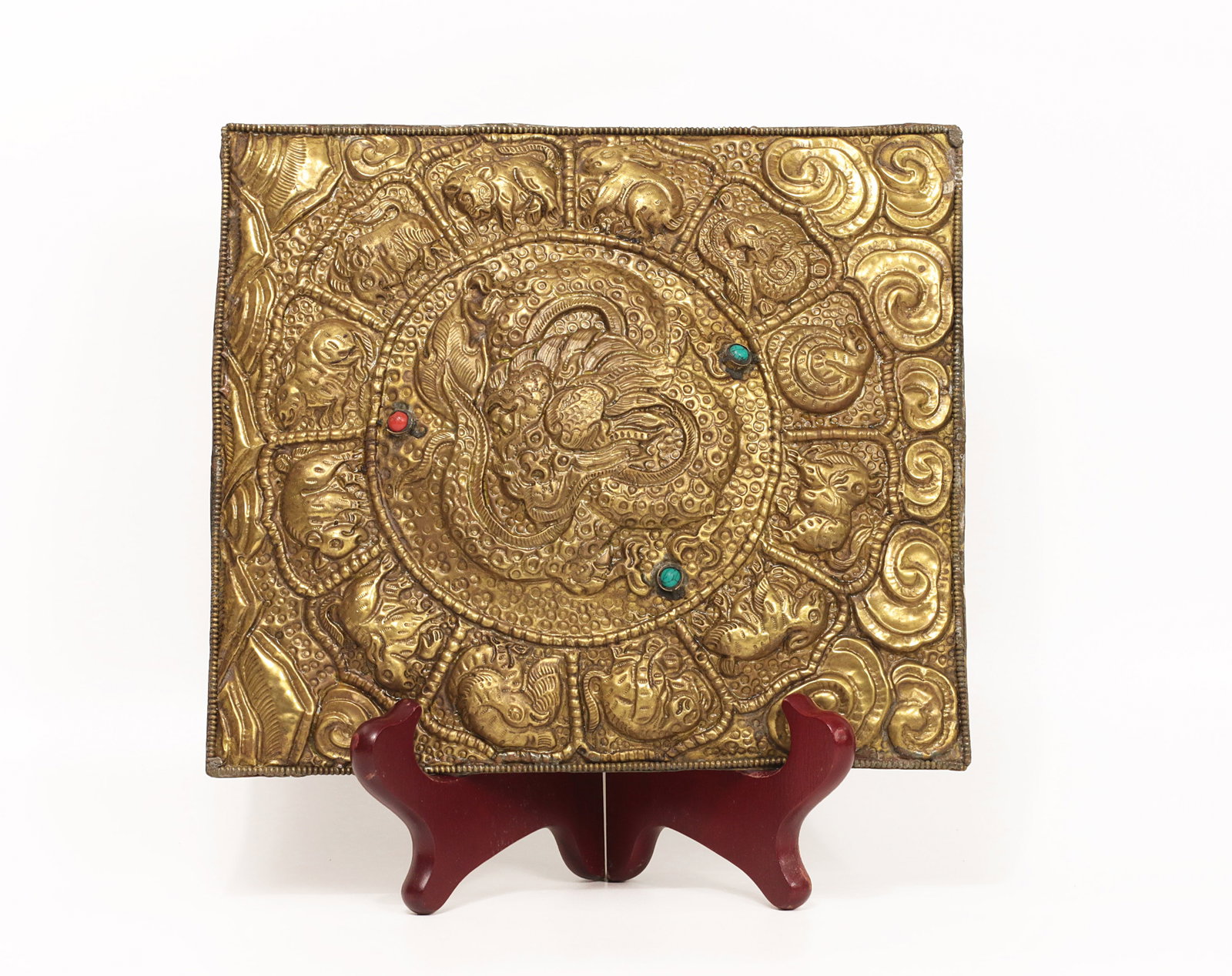Tibet 1960s Handmade Gilded and embossed Mandala with hardstone: Tibet. 1960s. Handmade Gilded and embossed Mandala with hardstone. Depicting the chinese Zodiac Signs with a dragon in the centre. Extremely fine. Marked on reverse with flowers. 450 gr. - 22x19 cm