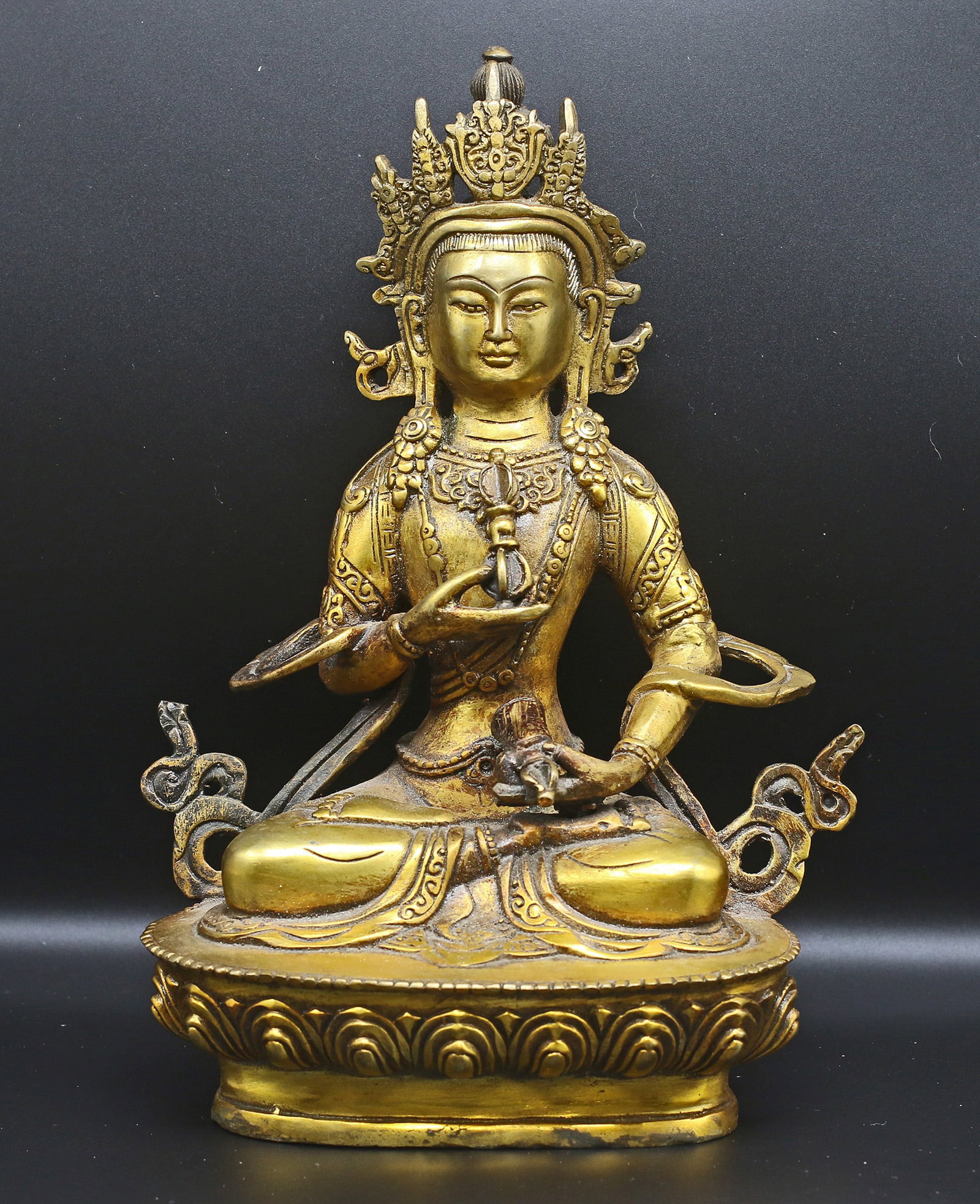Tibet 1960 Gold plated Vajrasatva Buddha 20cm - 839 gr.: Tibet. 1960. Gold plated Vajrasatva Buddha, sitting on the sacred "Lotus flower", with bell and Phurba. 20x13x9 cm - 839 gr. Exceptional ornate details. Extremely fine.
