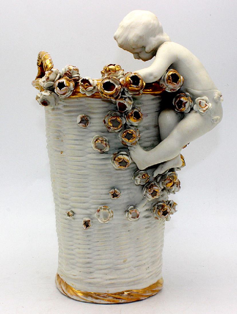 Imperial Amphora Two Handle Vase Mounted with Flowers &: Imperial Amphora Two Handle Vase Mounted with Flowers & a Putti. 10 1/2" high x 5 1/2" wide.