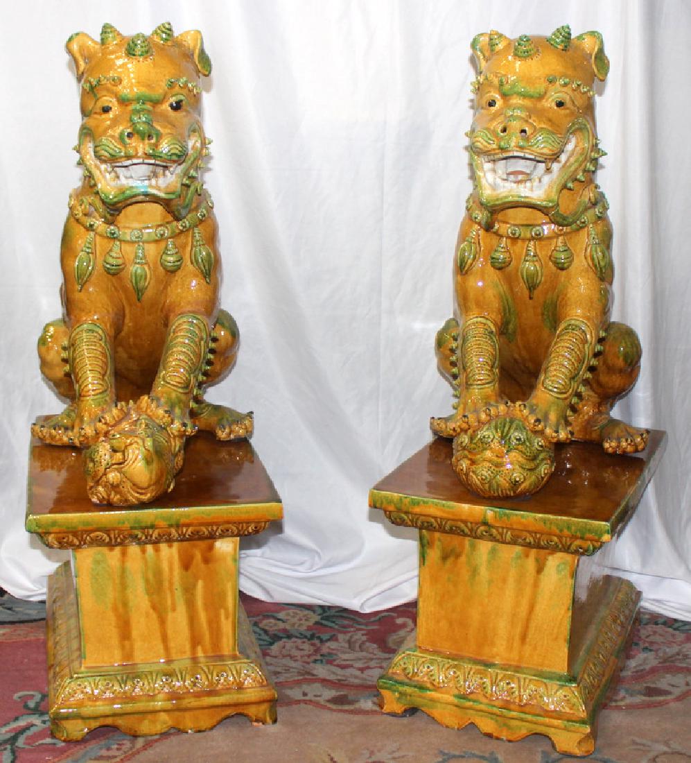 Pair of Hand Decorated Porcelain Palace Size Foo Dogs: Pair of Hand Decorated Porcelain Palace Size Foo Dogs. 41.5" h x 14.25" w x 25.5" depth.