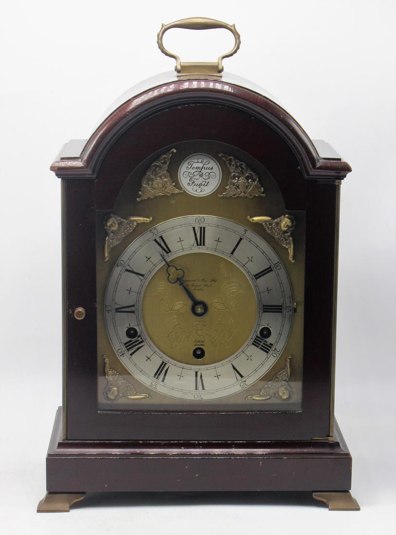 Elliot London Mahogany Chinese Bracket Clock: Elliot London Mahogany Chinese Bracket Clock. Measures - 14.75" h x 9.25" long x 5.75" w. Comes with key.