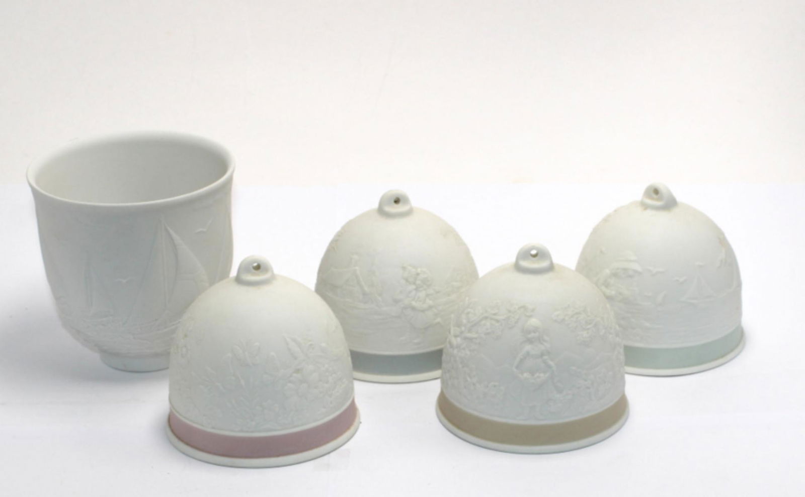 Five Pcs Lladro Porcelain Bells and Cups: Five pcs Lladro porcelain bells and cups. One the sea sail boat cup measures 3" H. four christmas bells measure 3 1/2" H