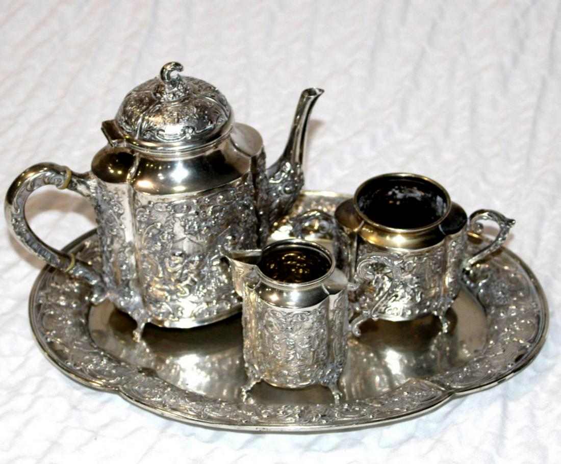 Four Pcs German Silver Tea Set: Four pcs German 800 silver tea pot includes tray measures 11 1/2" x 8 1/2", teapot measures 6 1/2" H and sugar and creamer measures 2 3/8" H weighs 30 OZT