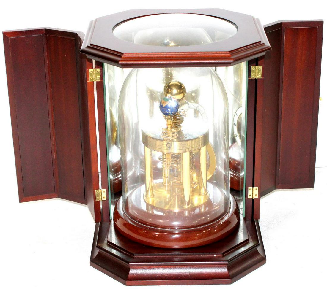 Franz Hermle and Sohn Astrolabio Desk Clock: Franz Hermle and Sohn astrolabio desk clock, late 20th century battery operated inlaid stone and brass mahogany base marked design Richard Hermle W2987 made in germany measures 10" H glass case sold a