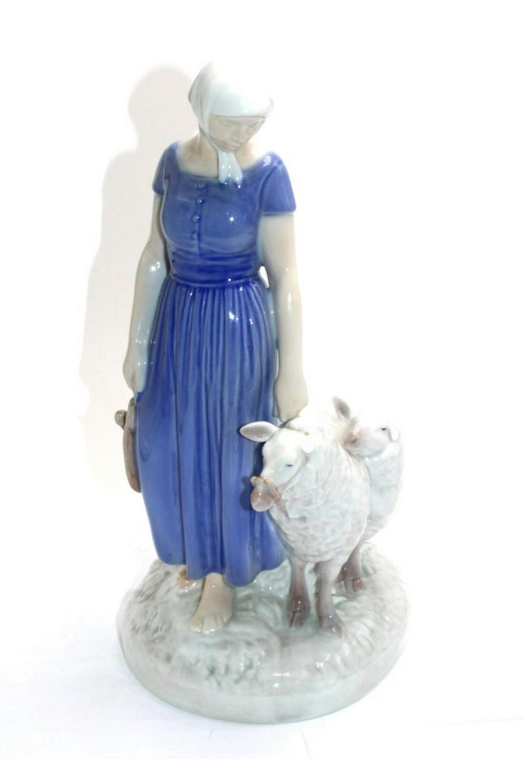 Bing and Grondahl Porcelain Figurines: Bing and Grondahl shepherds girl with sheep porcelain figurines measures 10 1/2" H. Both sheep missing one ear, sold as is