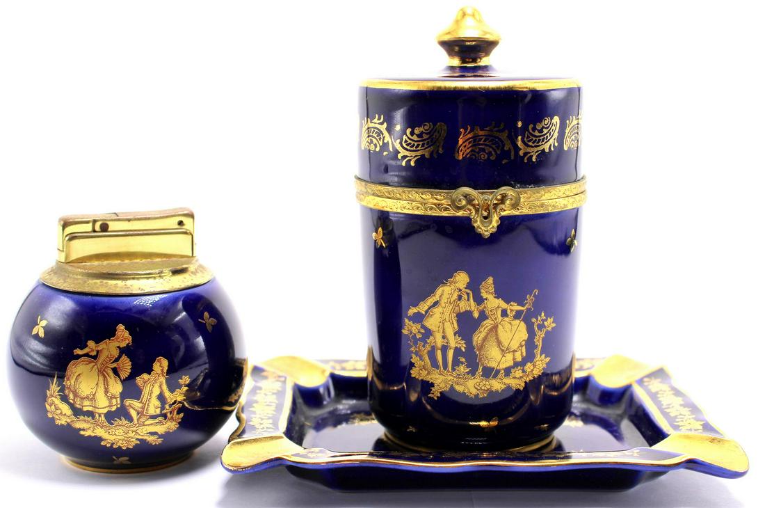 Three Pcs Limoges France Veritable Blue and Gold: Three pcs Limoges France veritable blue and gold porcelain set includes hinged lidded jar, tray and lighter measures 4 1/2" x 2 3/4"