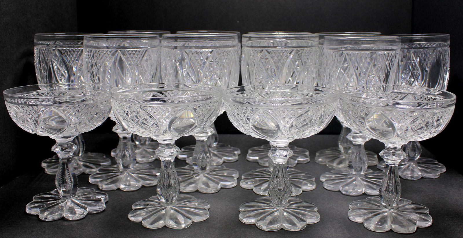 Thirteen Thomas Webb Glass Water Goblets and Four: Thirteen Thomas Webb glass water goblets measures 6 1/4" H and four champagne glasses measures 4 1/2" H