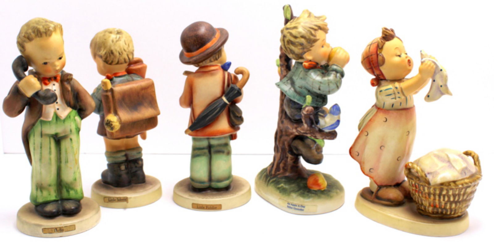 Five Goebel Hummel Figurines: Five Goebel Hummel figurines includes wash day, hello little scholar, an apple a day and little fiddler measures 6 1/2" x 6"