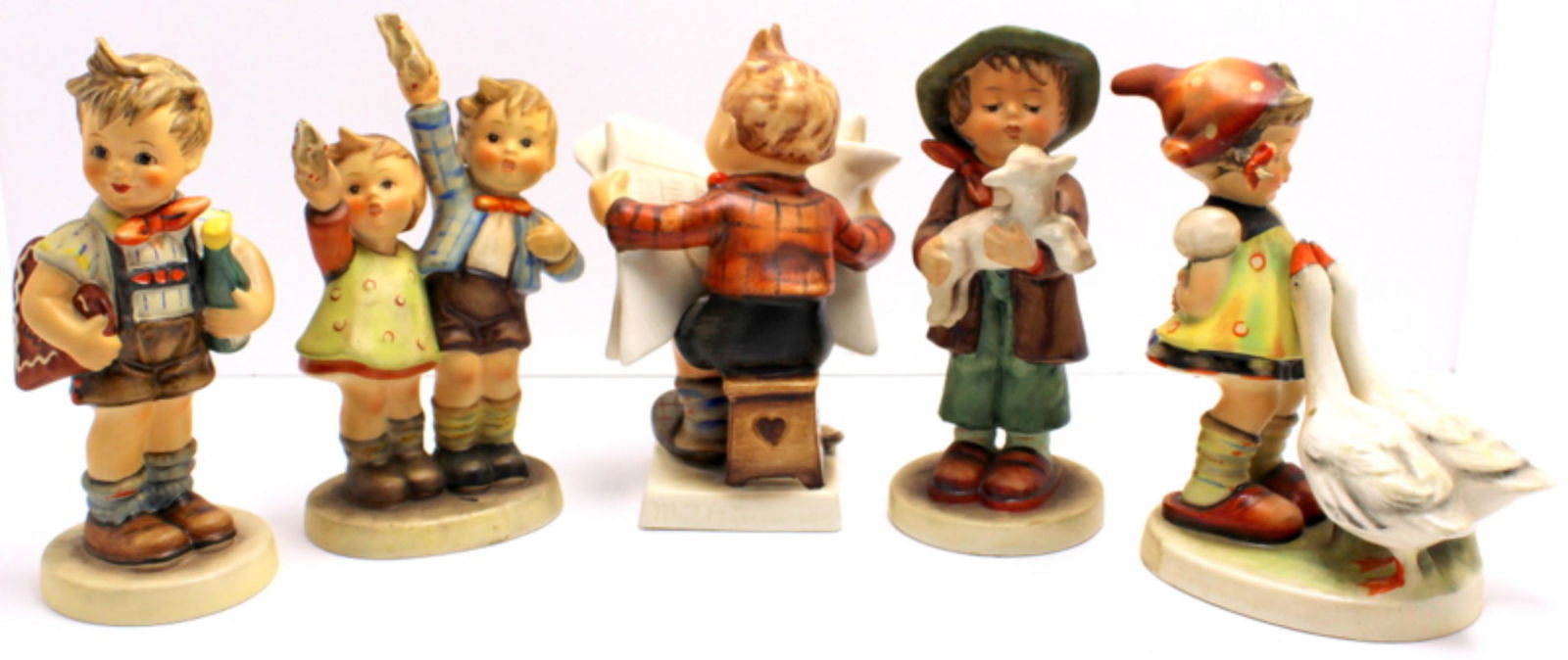 Five Goebel Hummel Figurines: Five Goebel Hummel figurines includes auf wiederscher, boy with lamb, valentin joy and goose girl and boy reading measures 5 1/2" High