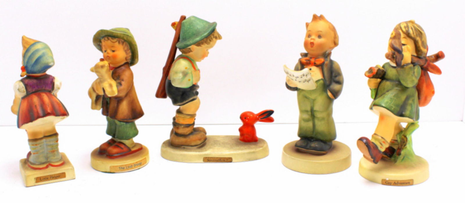 Five Goebel Hummel Figurines: Five Goebel Hummel figurines includes sensitive hunt, solosit boy, little helper, the lost sheep and gay adventure measures 4 3/4" High