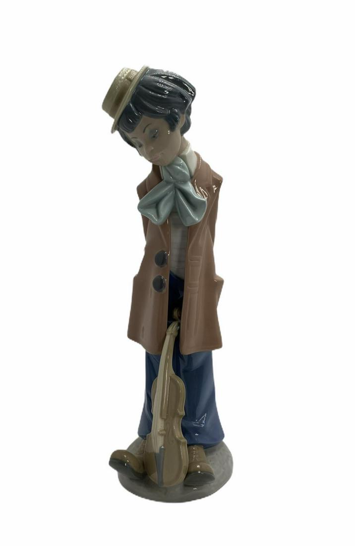 Lladro #5057 Boy with Violin Porcelain Figure: Lladro #5057 Boy with Violin Porcelain Figure measures 12" H