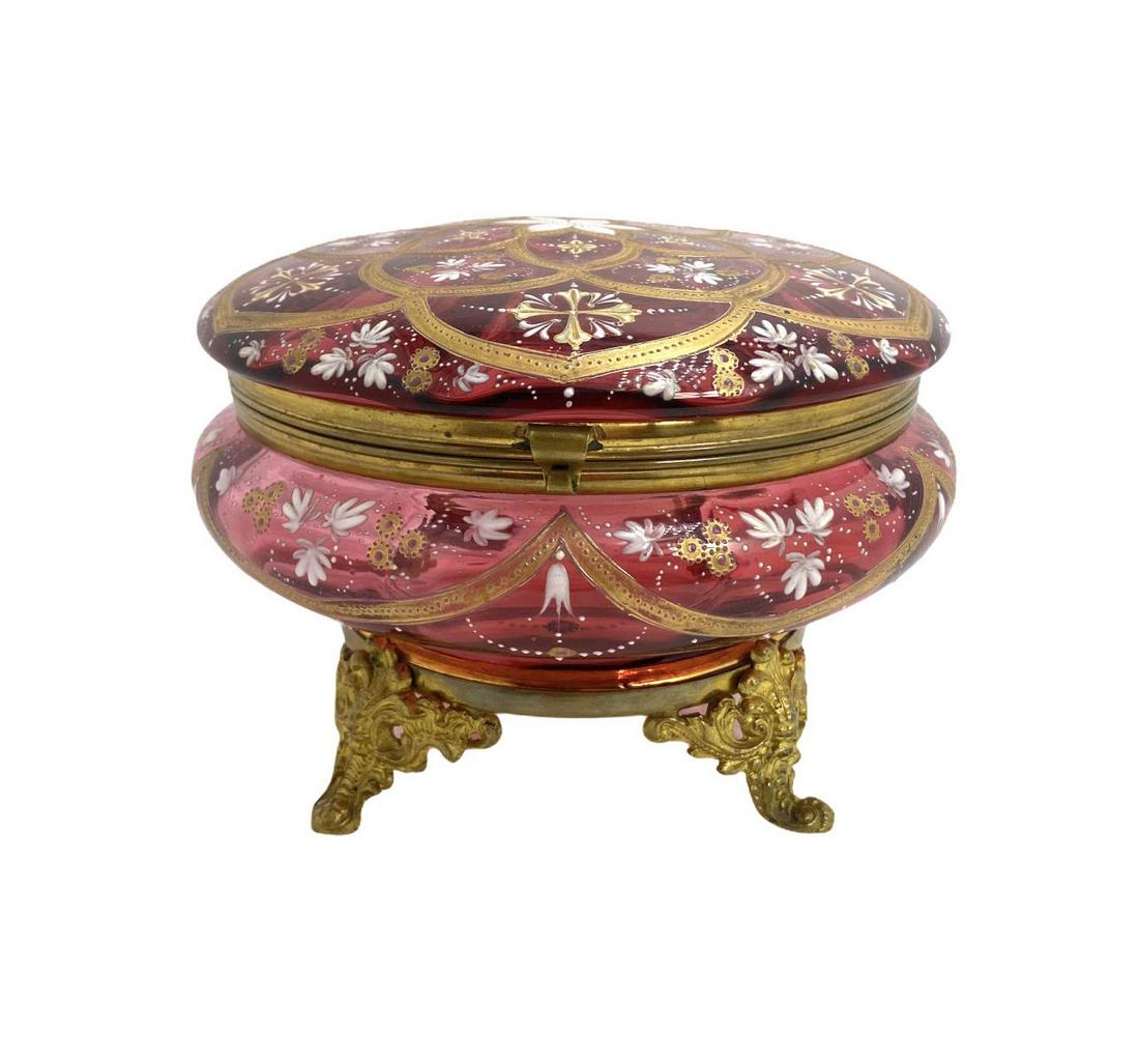 Moser Art Glass Cranberry Gold and Enamel Covered Box: Moser Art Glass Cranberry Gold and Enamel Covered Box with Brass Mounted Feet measures Height: 5" x Diameter: 7"