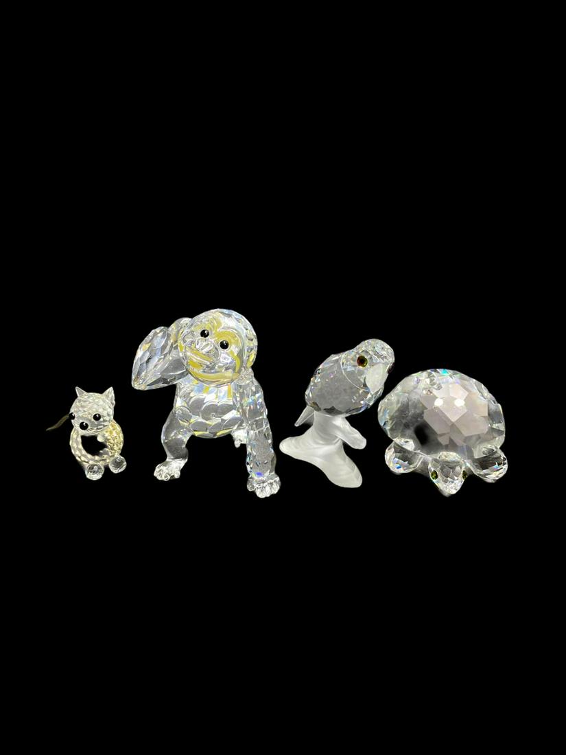 Four Pcs Swarovski Crystal Figurines: Four Pcs Swarovski Crystal Figurines includes turtle measures Height: 1 1/4", parrot measures Height: 2", monkey with banana measures Height: 2 3/8" and little cat measures Height: 1 1/4"