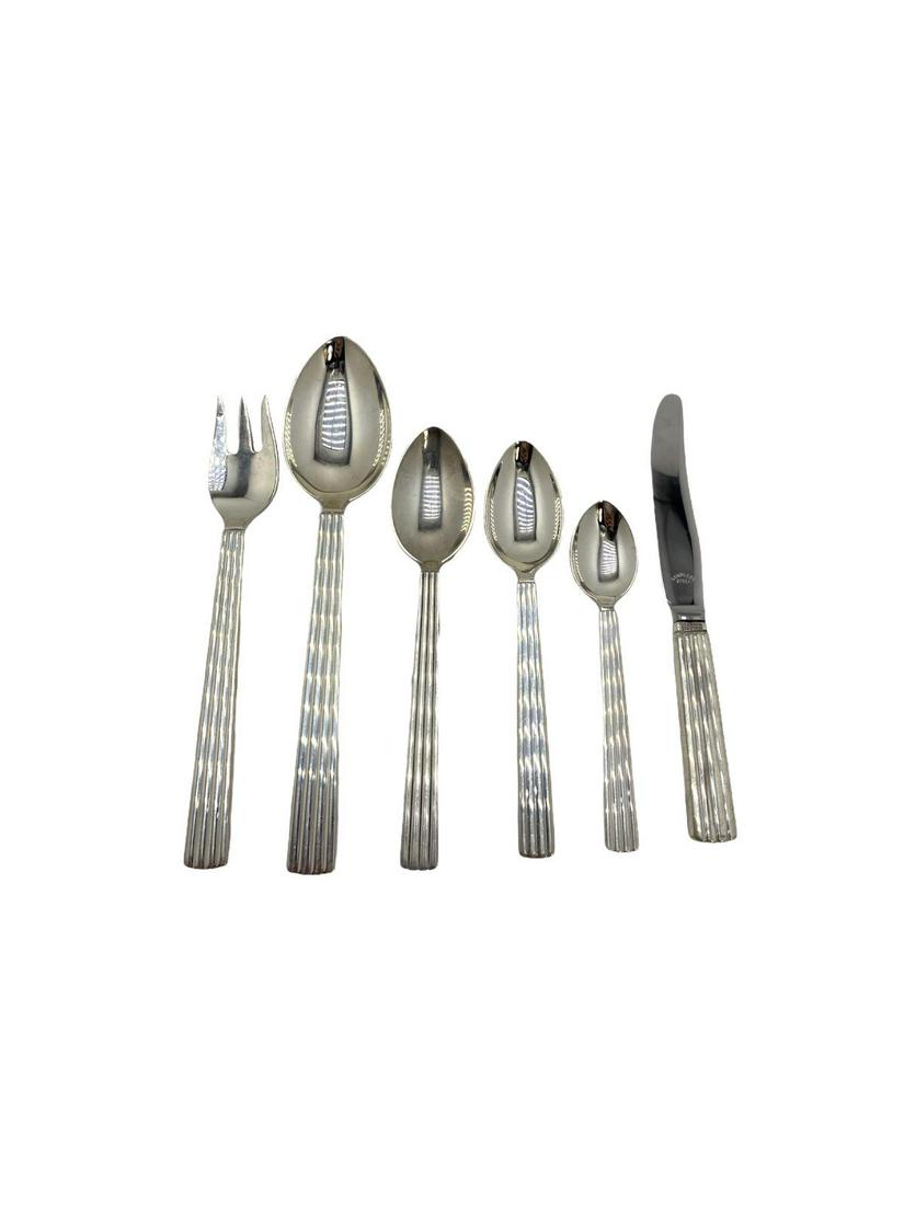 18 Pcs Georg Jensen Sterling Silver Bernadotte Pattern: 18 Pcs Georg Jensen Sterling Silver Bernadotte Pattern Serving Pcs includes 3 fruit knives, 4 fish forks, 3 teaspoons, 3 cream soup spoons, 4 demitasse spoons and 1 large teaspoon weighs 20.14 OZT