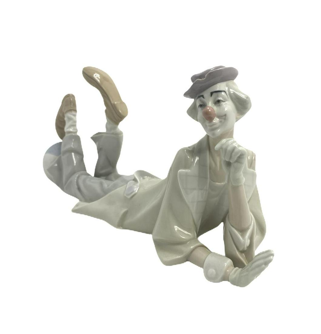 Lladro #4618 Clown with Ball Porcelain Figure: Lladro #4618 Clown with Ball Porcelain Figure measures 6 1/4" H x 14" L. Hat has damage, sold as is