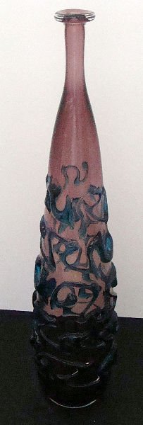 SIGNED PURPLE ART GLASS VASE: Signed Purple Art Glass Vase. Has a Scroll design throughout. Stands 17". Signed Medina. From The Malta Island design by famous glass maker Michael Harris. SHIPPING & REQUIRED INSURANCE $40.00 WITHIN 