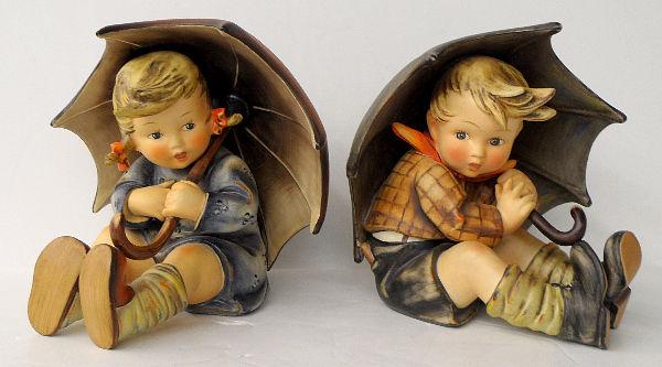 2 HUMMELS UMBRELLA BOY TMK-5 & UMBRELLA GIRL TMK-4: 2Pcs.Hummel figures Umbrella Boy & Umbrella Girl, umbrella girl has a TMK-4 Three line mark & the umbrella Boy has a TMK-5. The last bee mark each is 8" with a total book value of $2850.00. Height 8"
